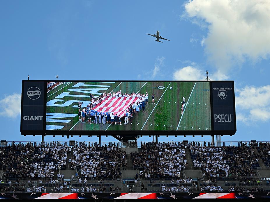 Plane flies over scoreboard