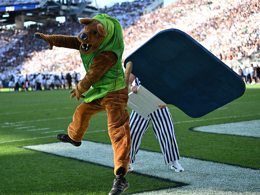 Mascot dressed as pickle hit by oversized paddle