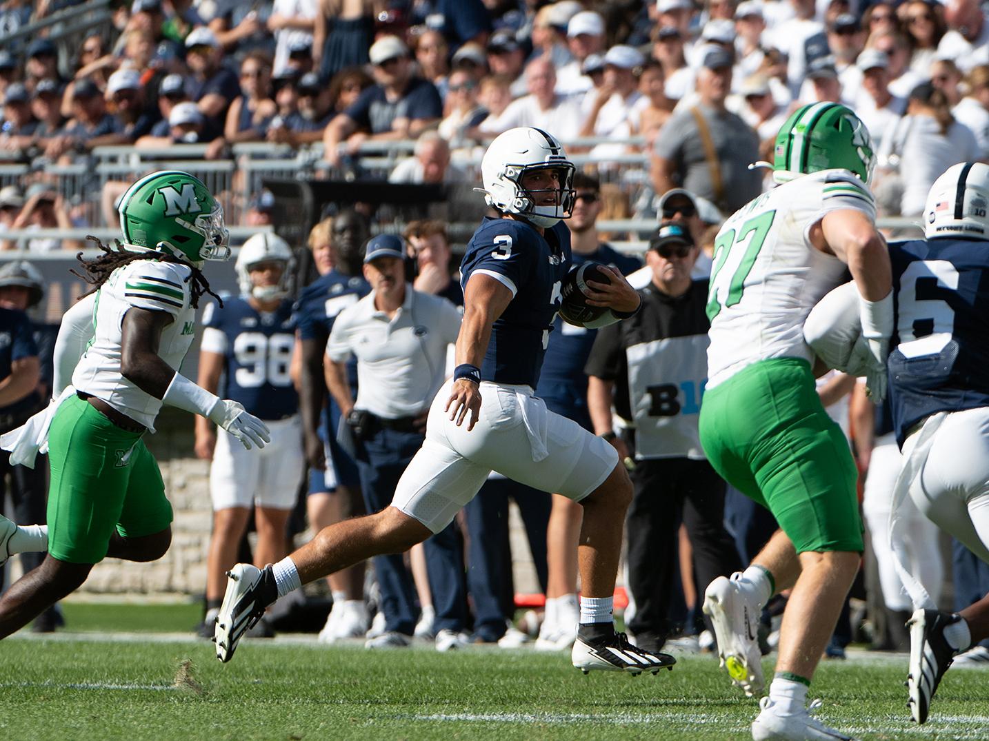 Quarterback runs away from defenders