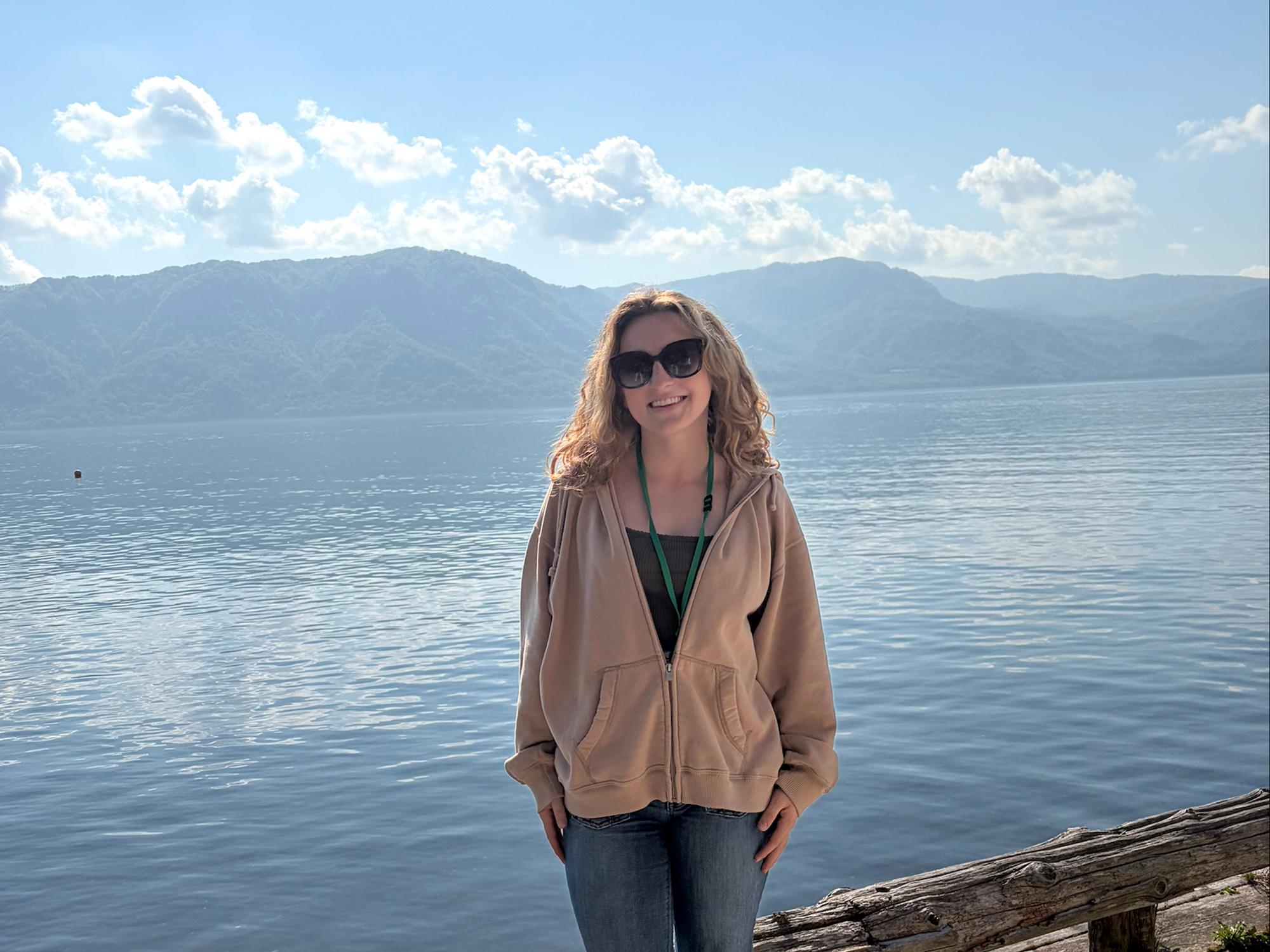 Student stands in front of lake while on educational trip to Japan.