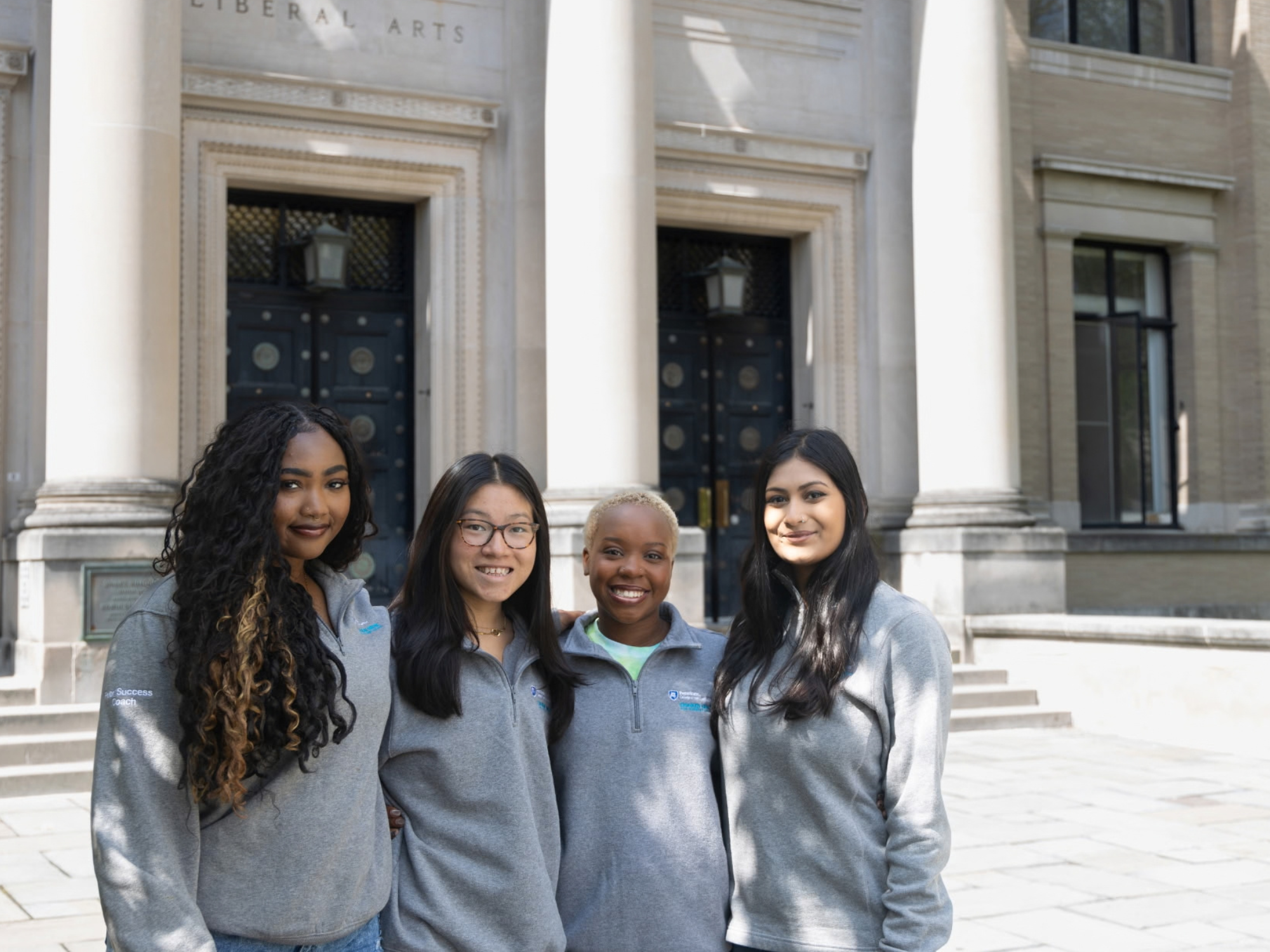 Nia Smith stands with three fellow students outside Sparks Building.