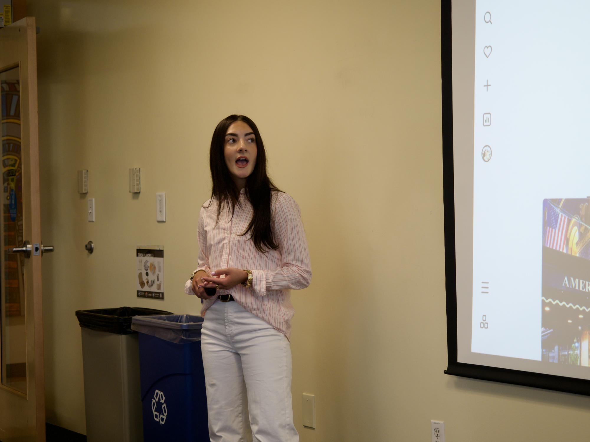 woman speaking in front of a room
