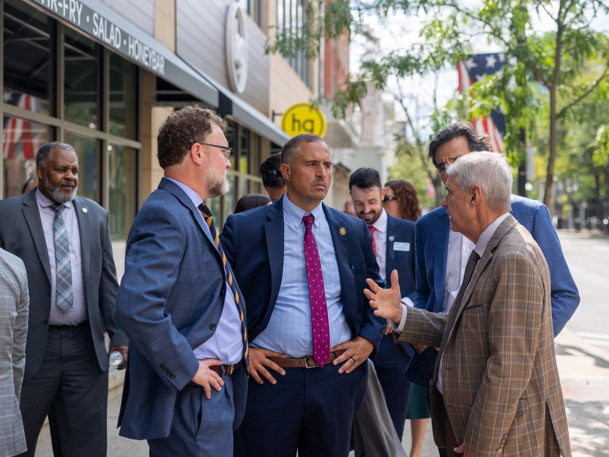 Ed LeClear, Tom Fountaine and Joseph DeFelice talking with each other during a tour of the State College Opportunity Zone.