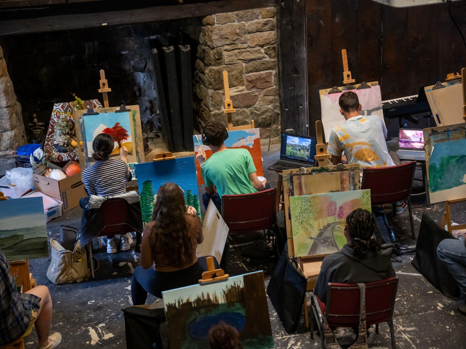 Students work at easels in the Mary Behrend Studio at Penn State Behrend.