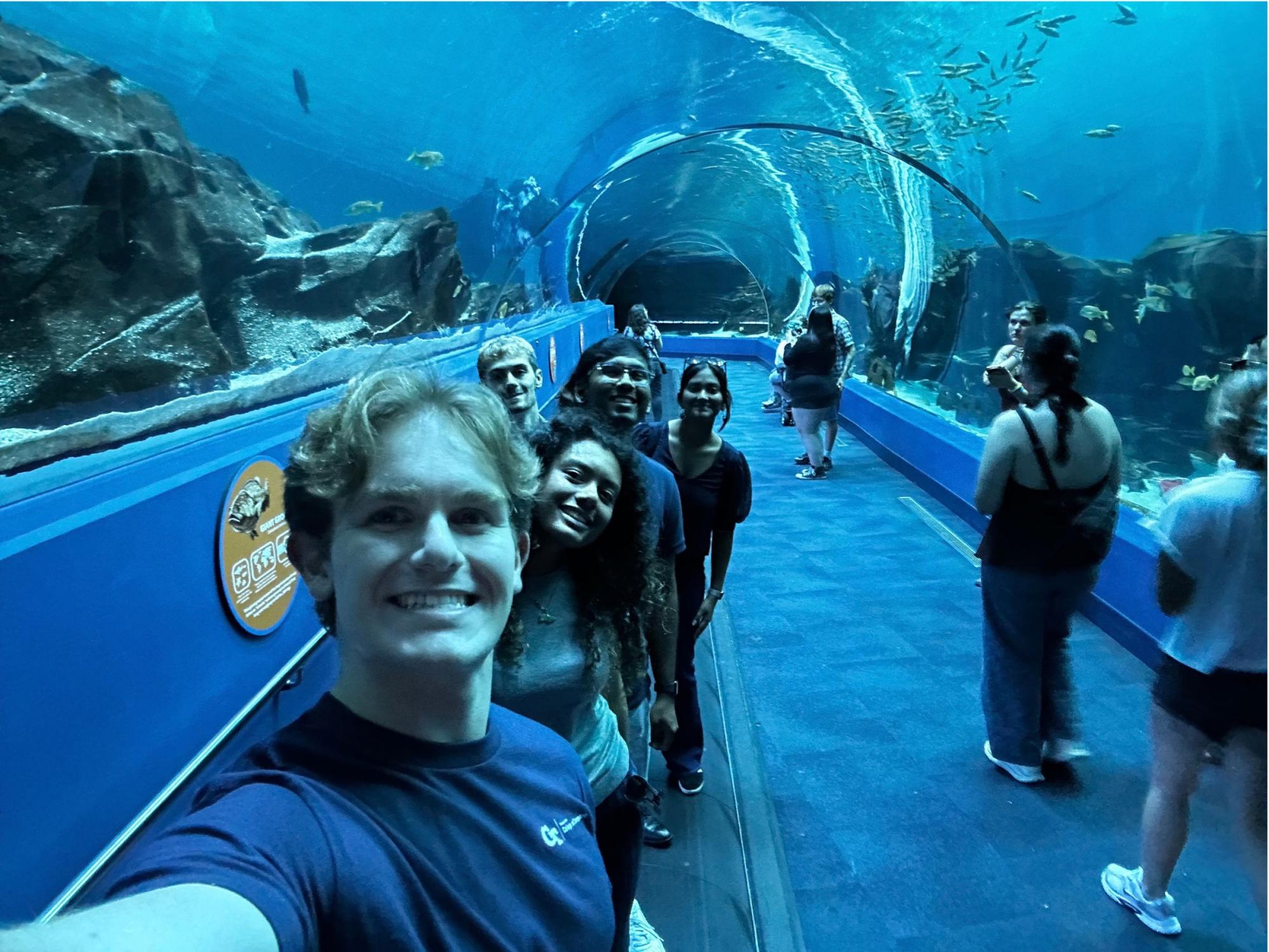 college students take selfies at the Georgia Aquarium