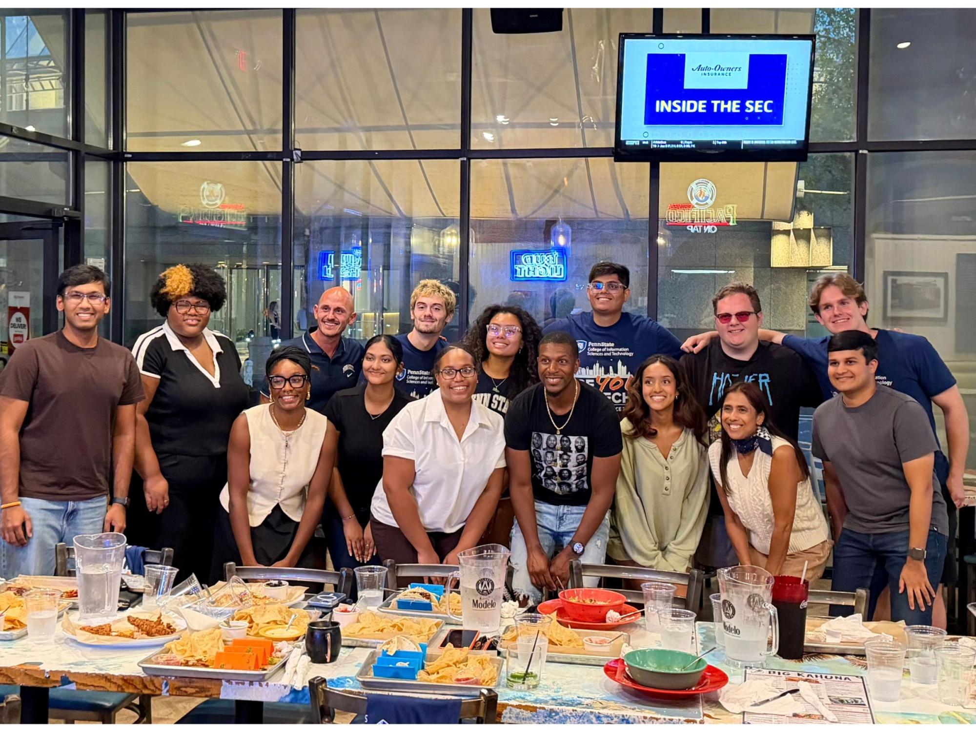 college students gather around buffet table