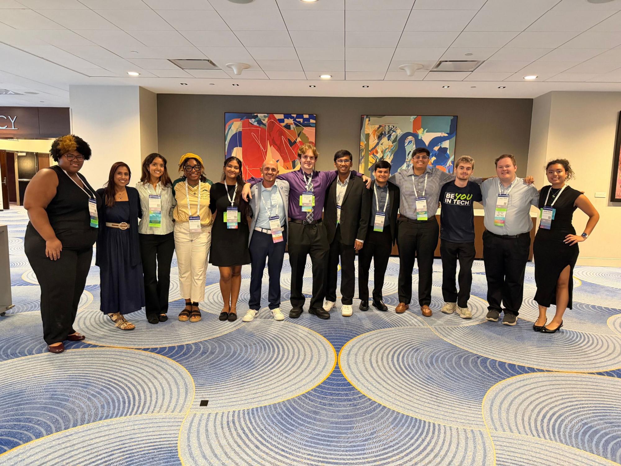 a row of conference attendees standing in hotel conference area