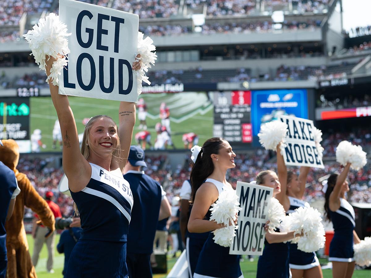 Cheerleaders hold signs