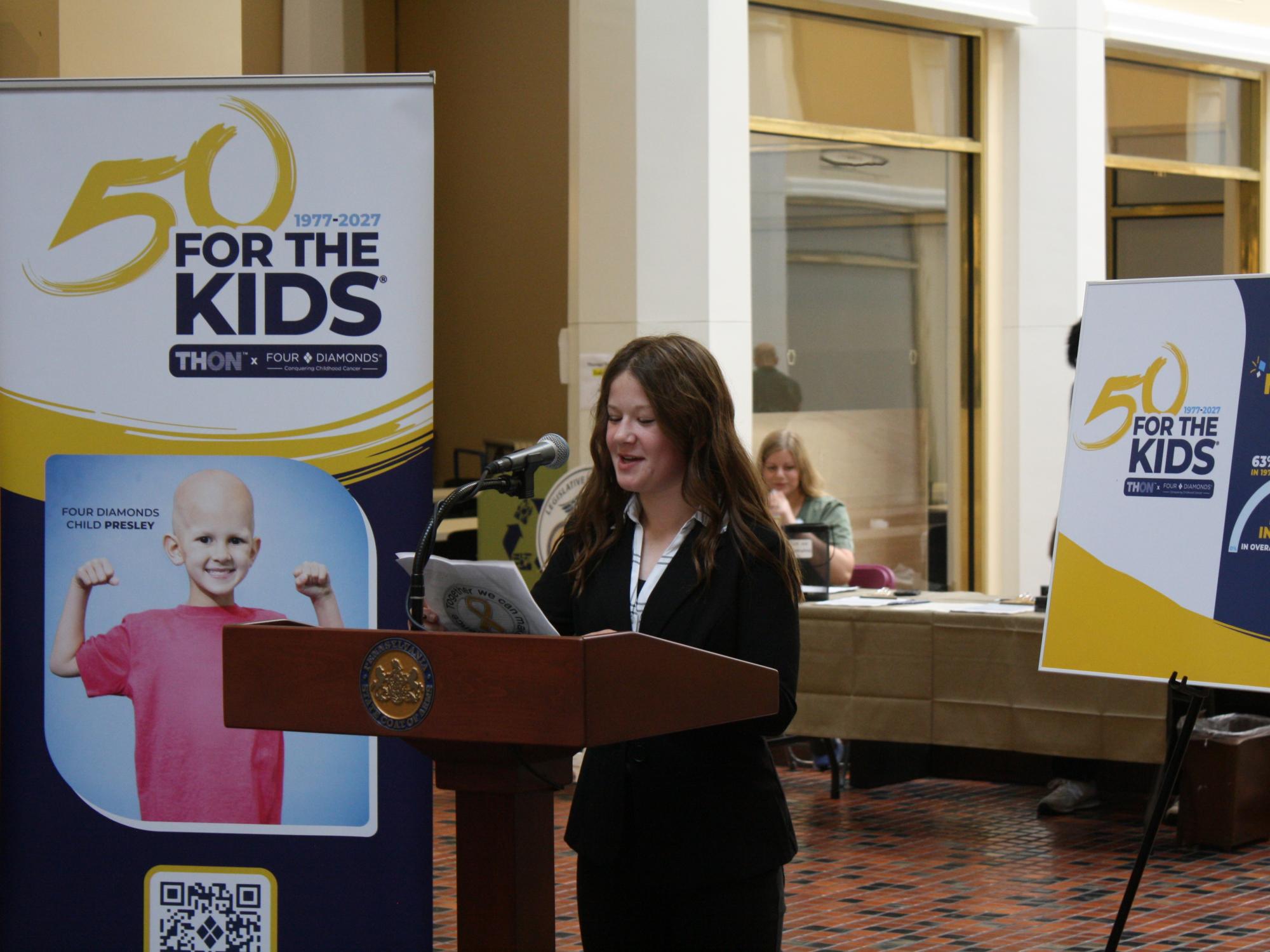 Four Diamonds child speaking at a podium in the state capitol building