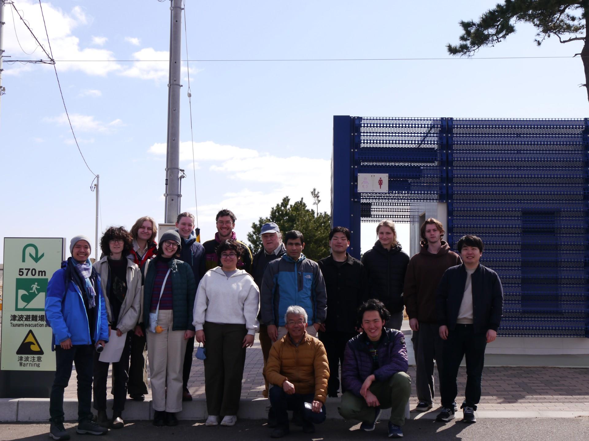 A group of students and faculty stand for a photo