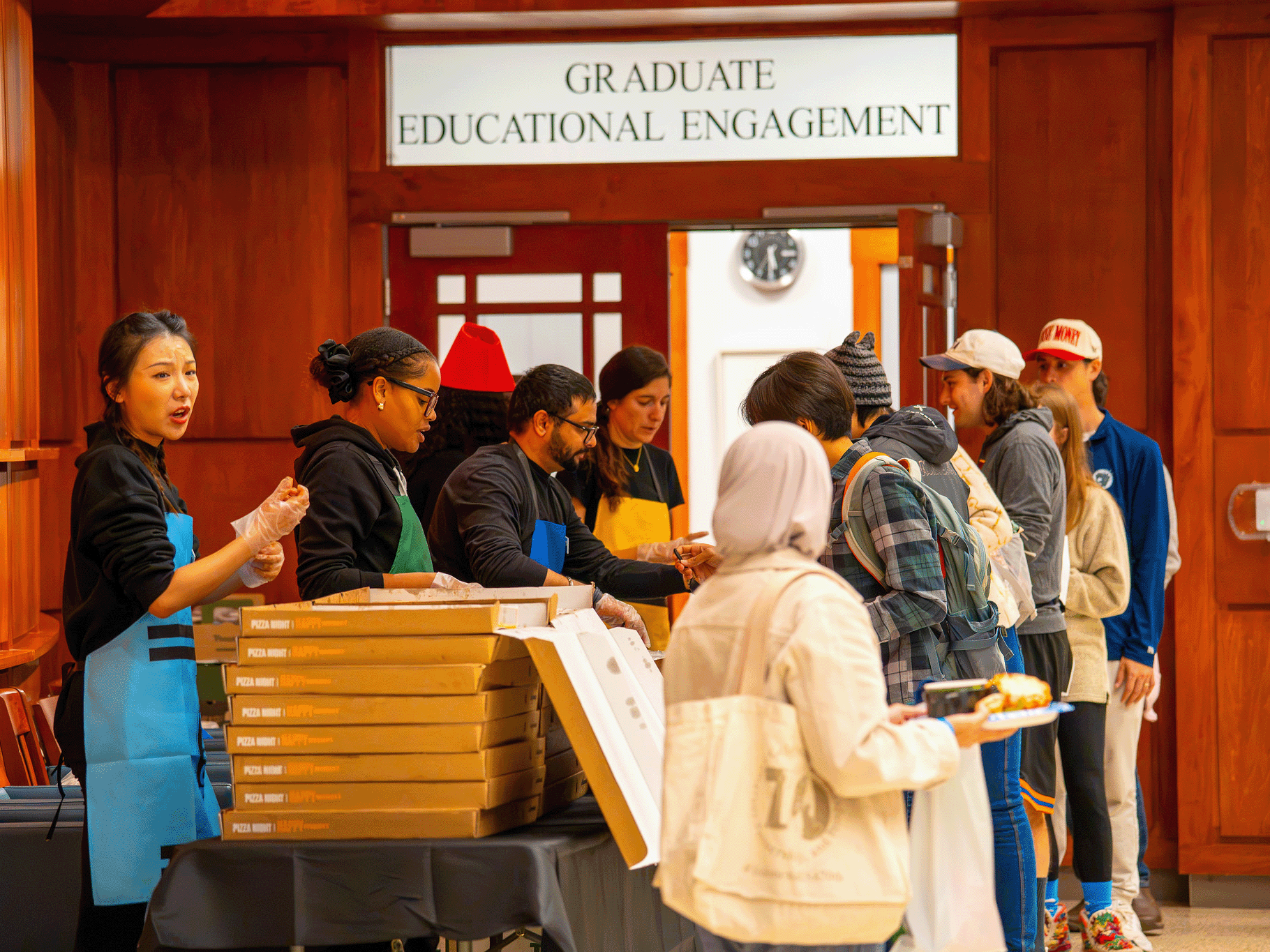 Graduate students line up for free pizza and soup; two of the several food and snack options at the Fall Festival.