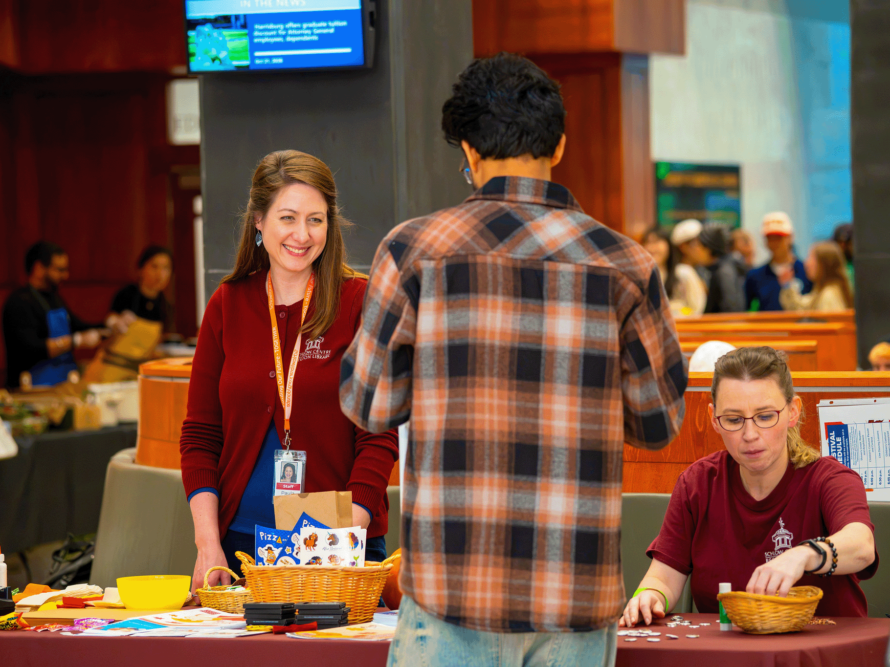 The Schlow Library, located in downtown State College, discusses their offerings with a graduate student.