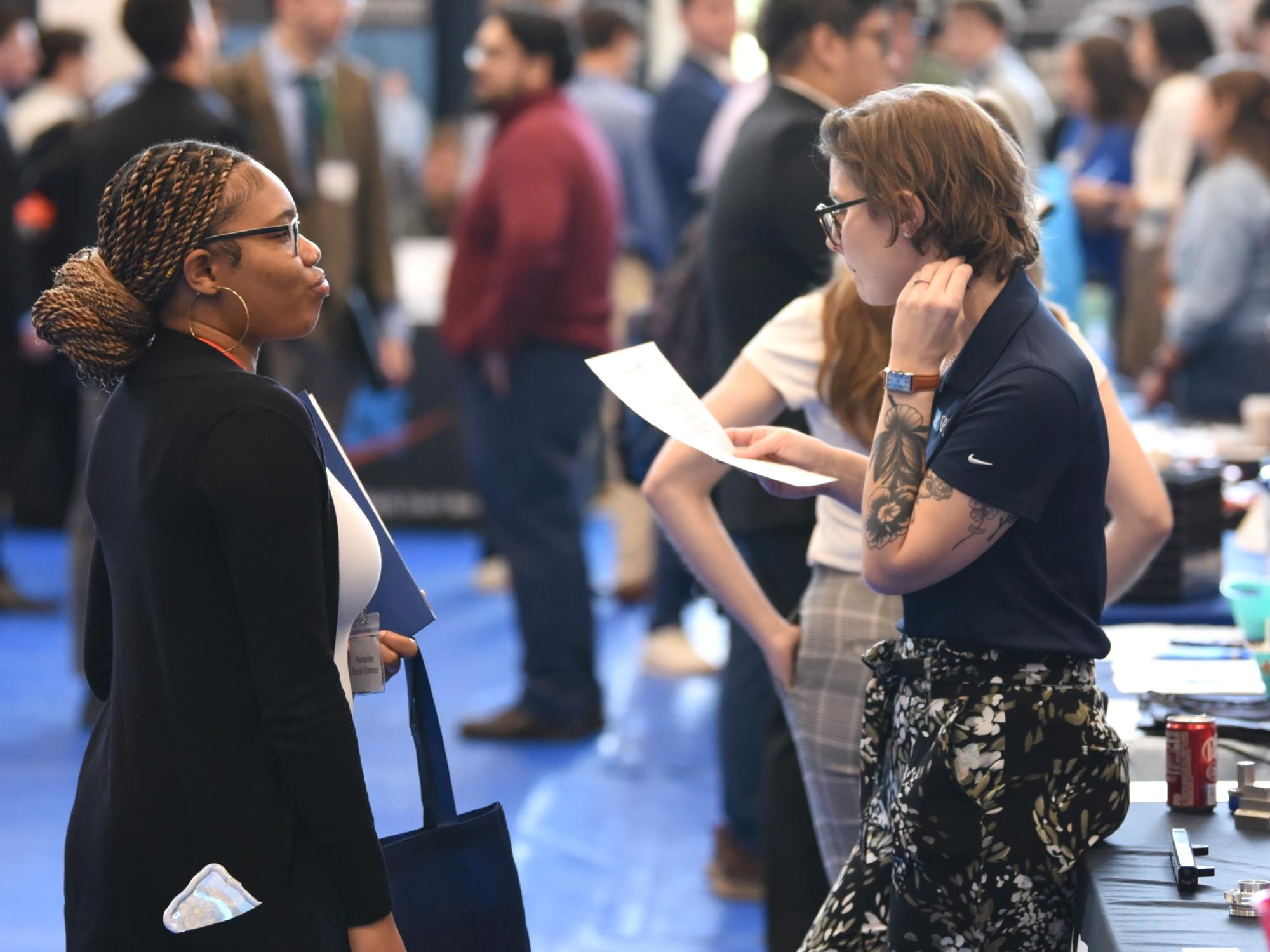 A student talks with a corporate recruiter at Penn State Behrend's fall Career and Internship Fair.