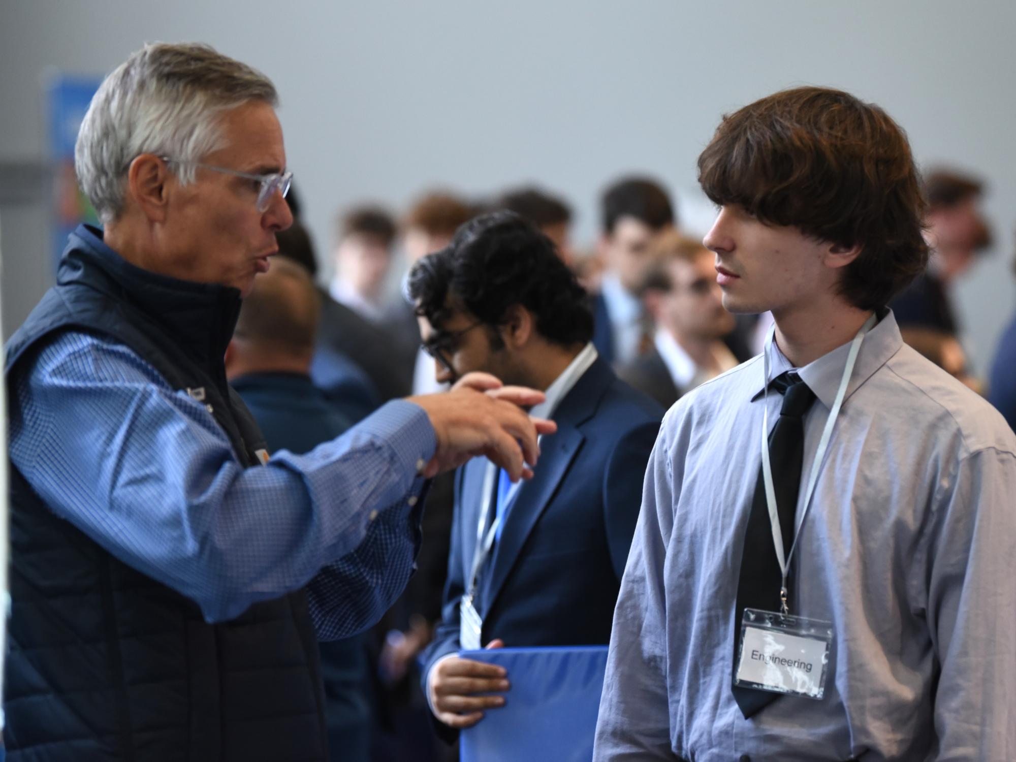 A recruiter talks with a student at Penn State Behrend's fall Career and Internship Fair.