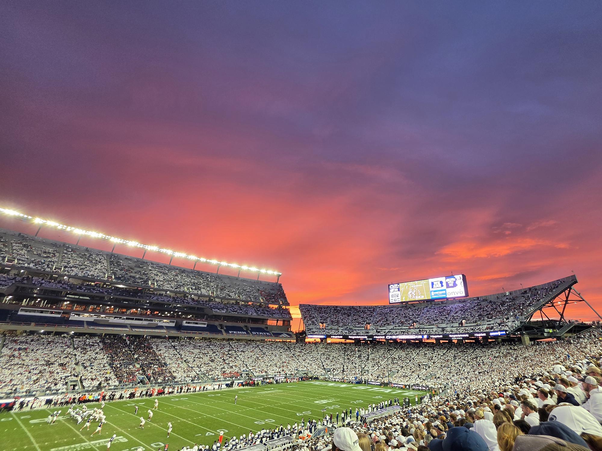 A vibrant sunset over a football stadium.