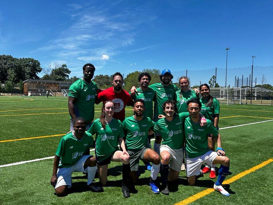 Daniel Garcia Calao wears a green jersey on a soccer field with teammates.