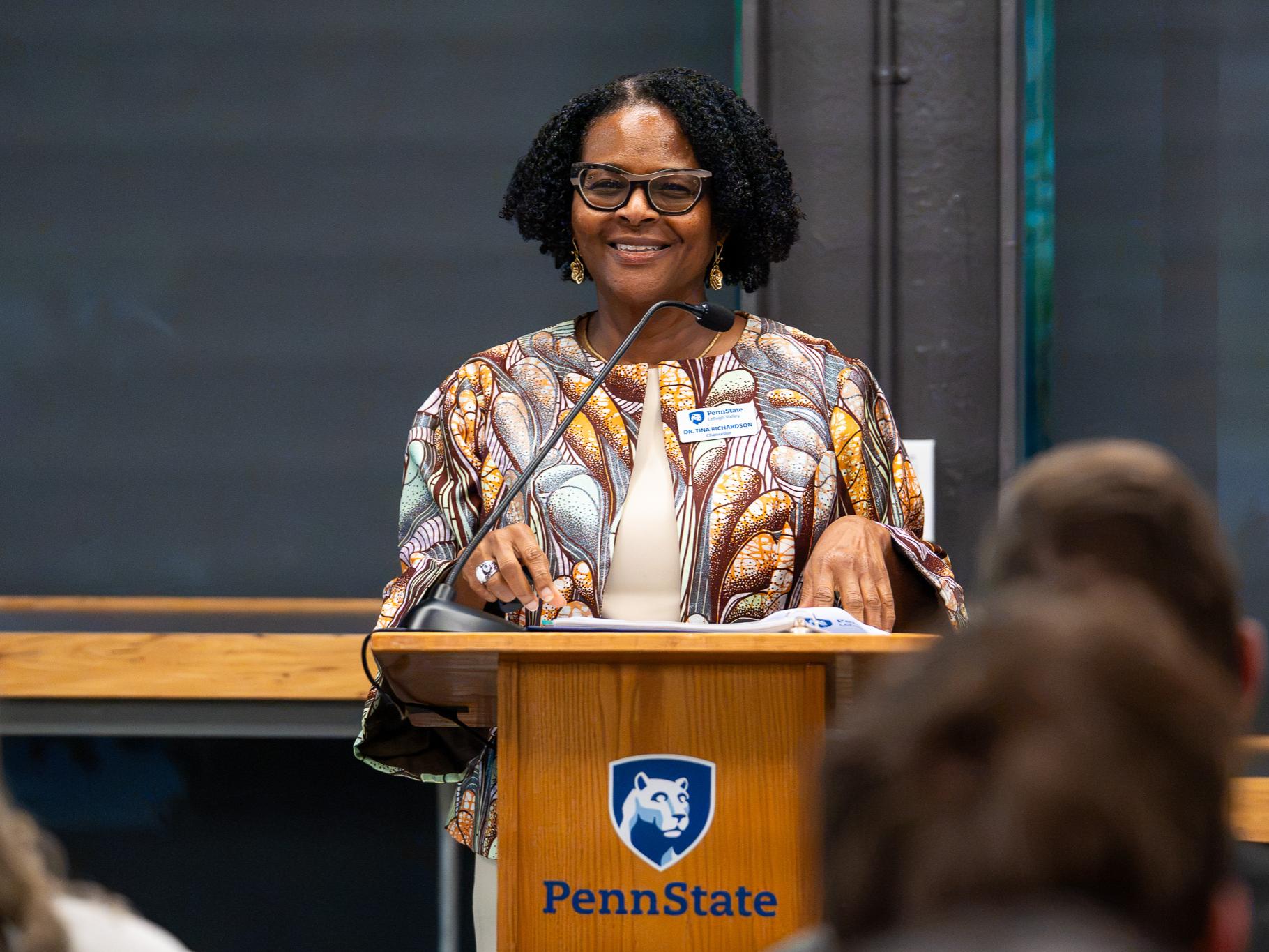 woman standing at a podium speaking