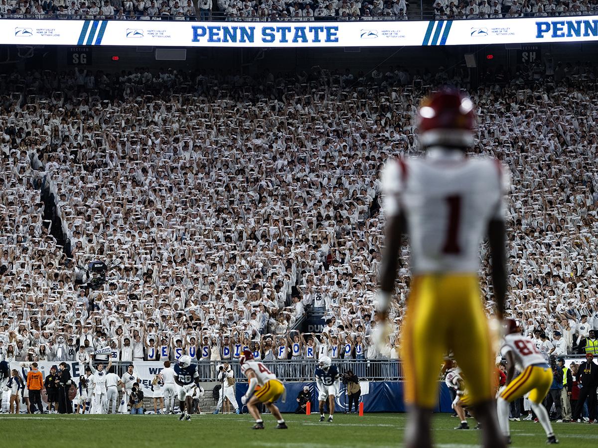 Wide shot of student section with opposing player in foreground