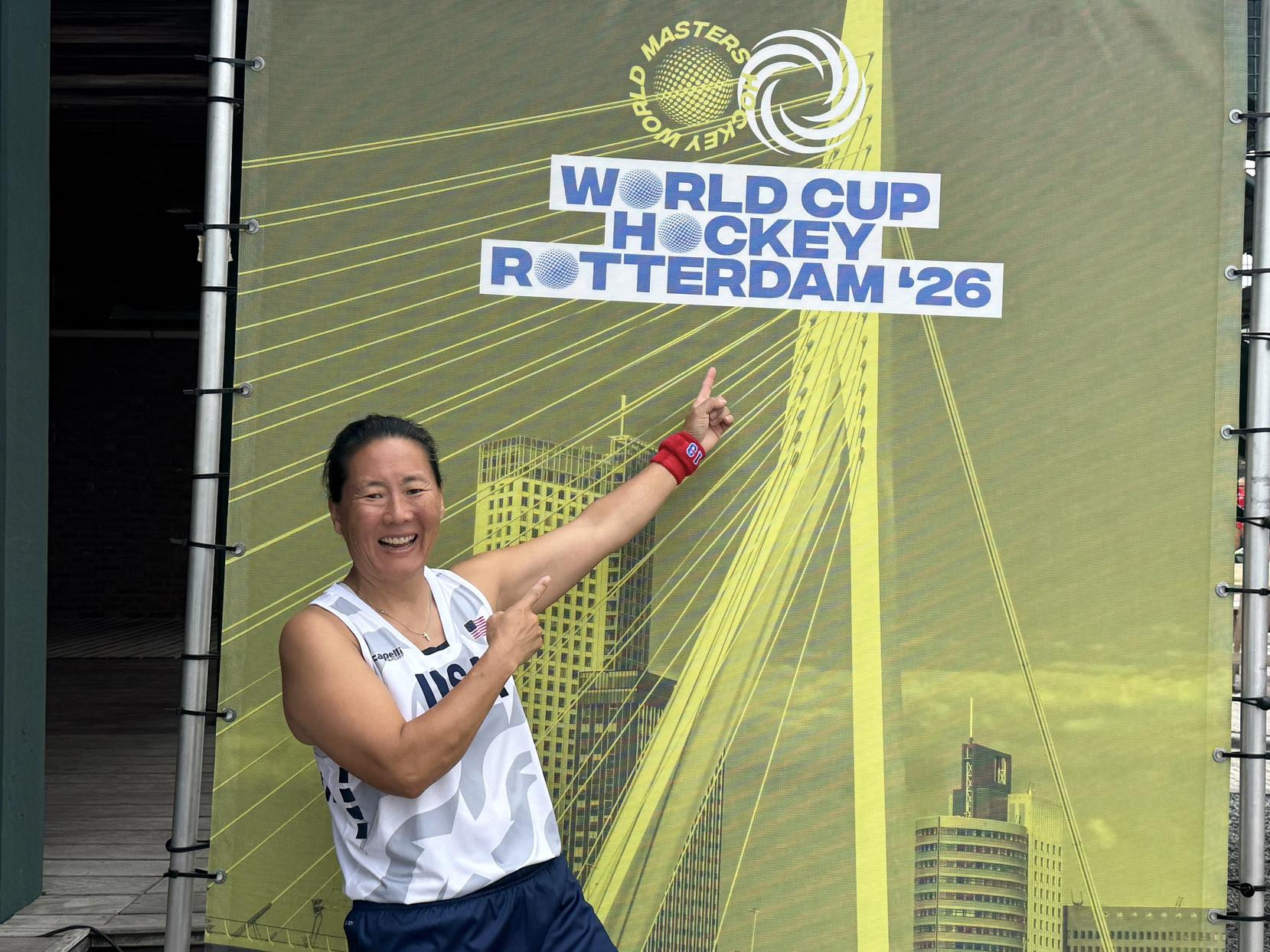 Amanda Janney Misselhorn points to a sign for World Cup Hockey 2026