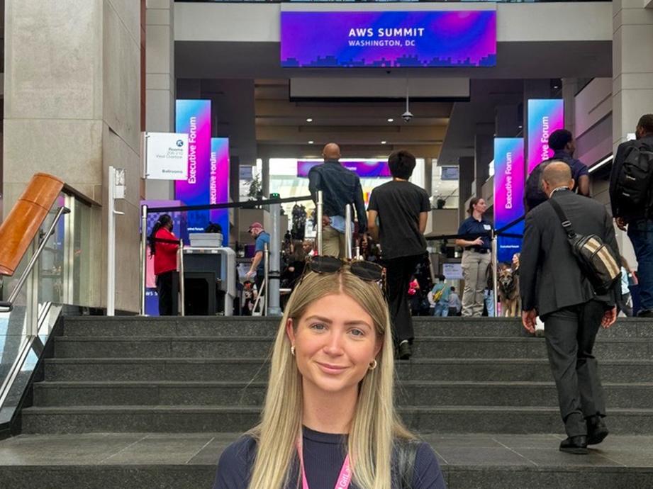 Erin Gregorian stands on a staircase while attending the Amazon Web Services Summit in Washington, D.C.