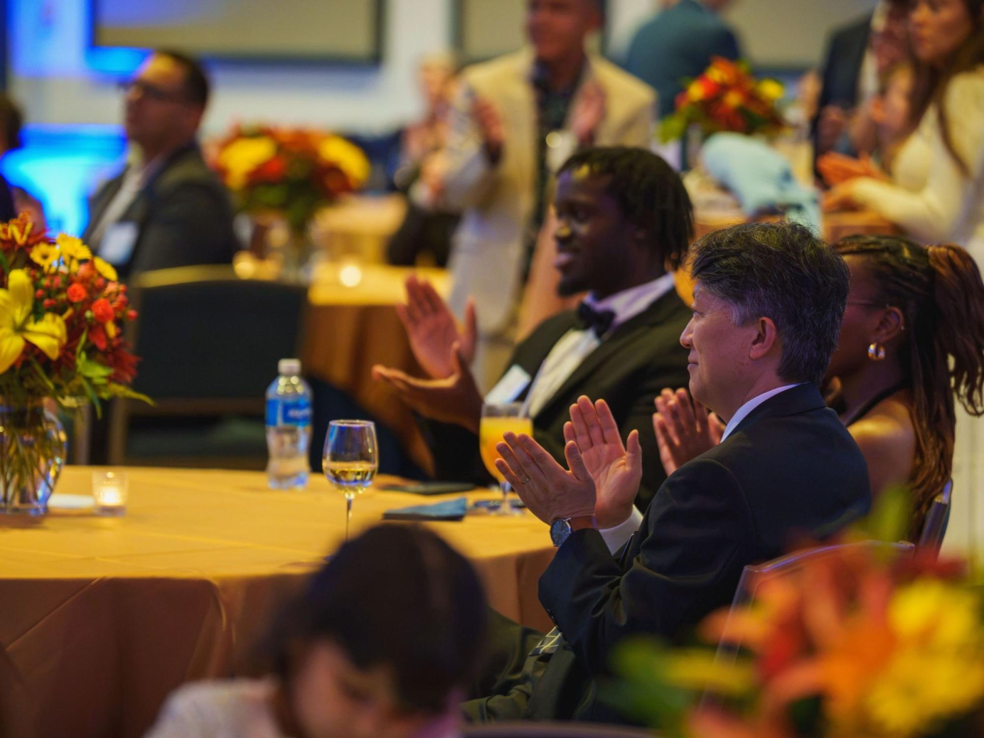 people seated at tables at formal gala