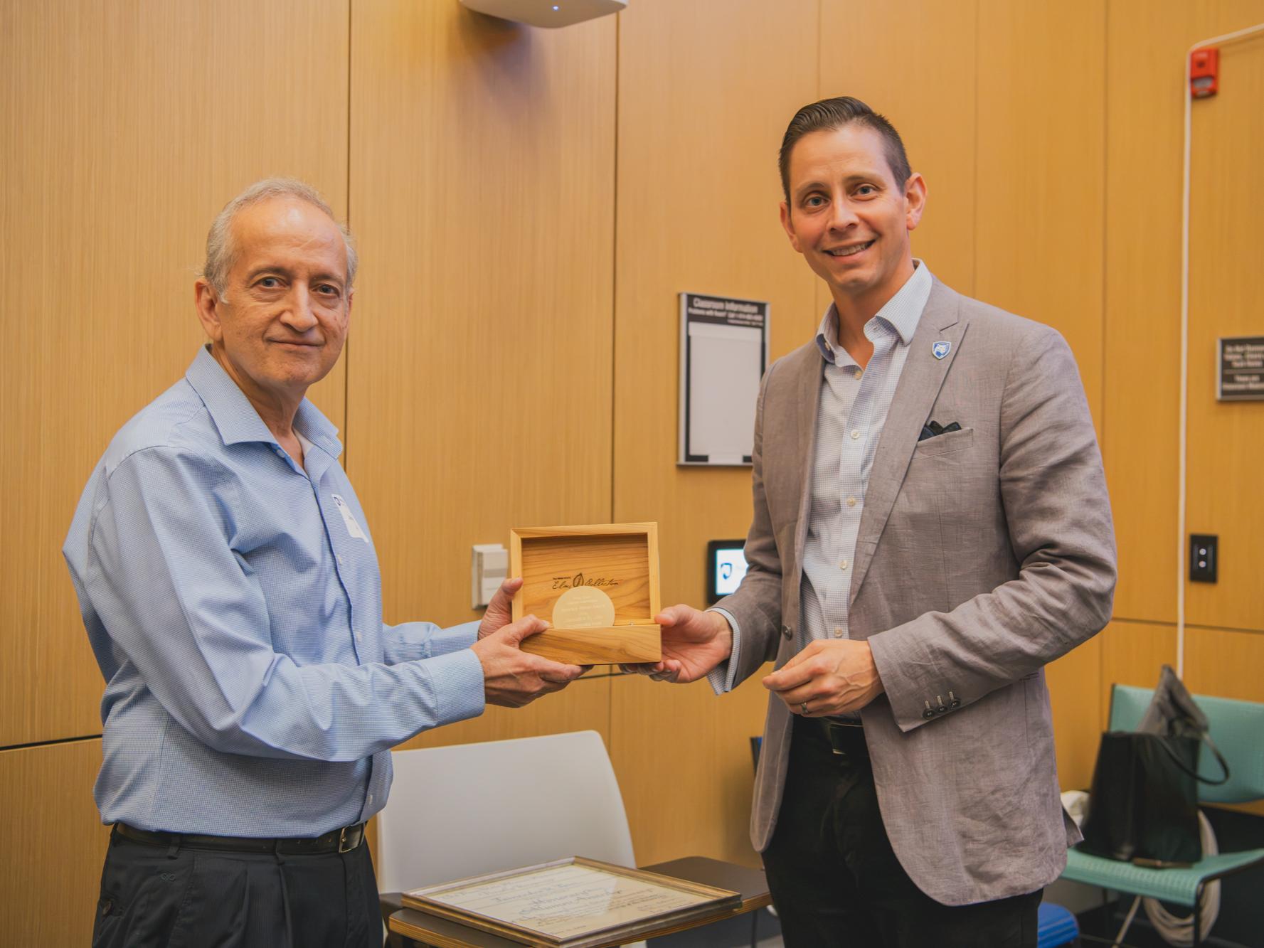 Jainendra Jain, Evan Pugh University Professor and Erwin W. Müller Professor of Physics and holder of the Eberly Family Chair in the Penn State Eberly College of Science, accepting the 2026 Honorary Alumni Award from Reggie Bustinza.