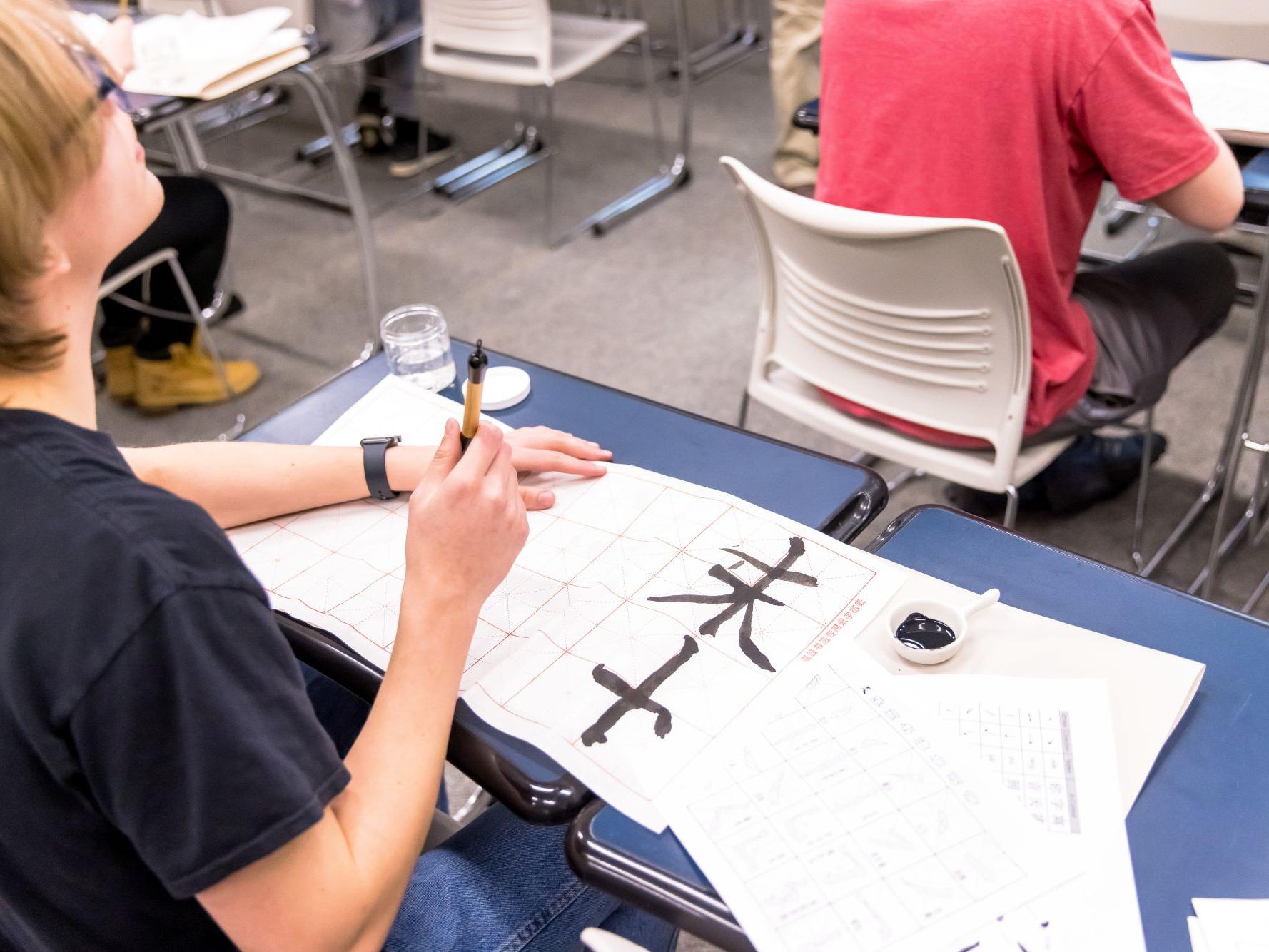 A student practices Chinese script in an innovative writing course at Penn State Behrend.
