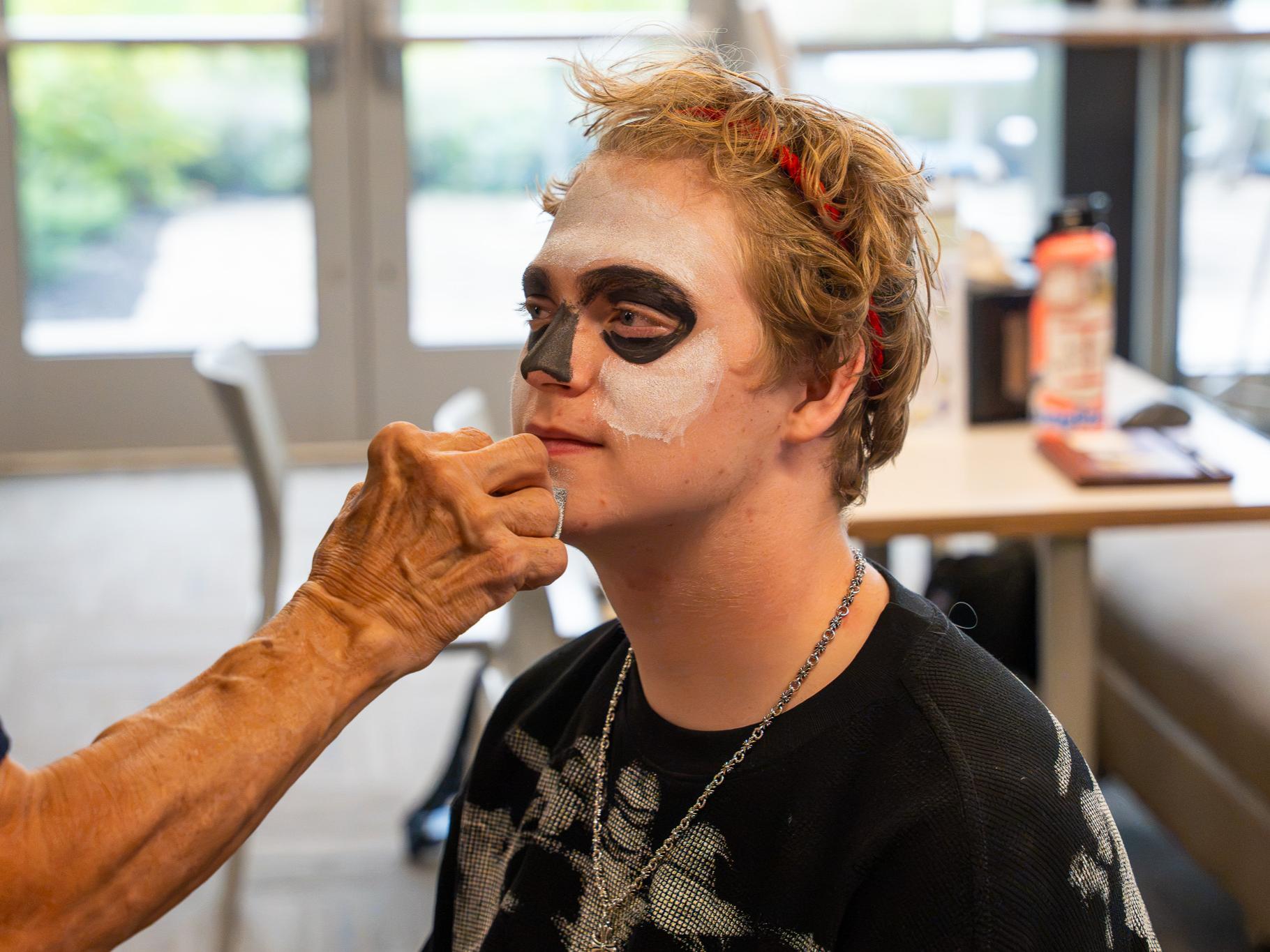 man having his face painted white