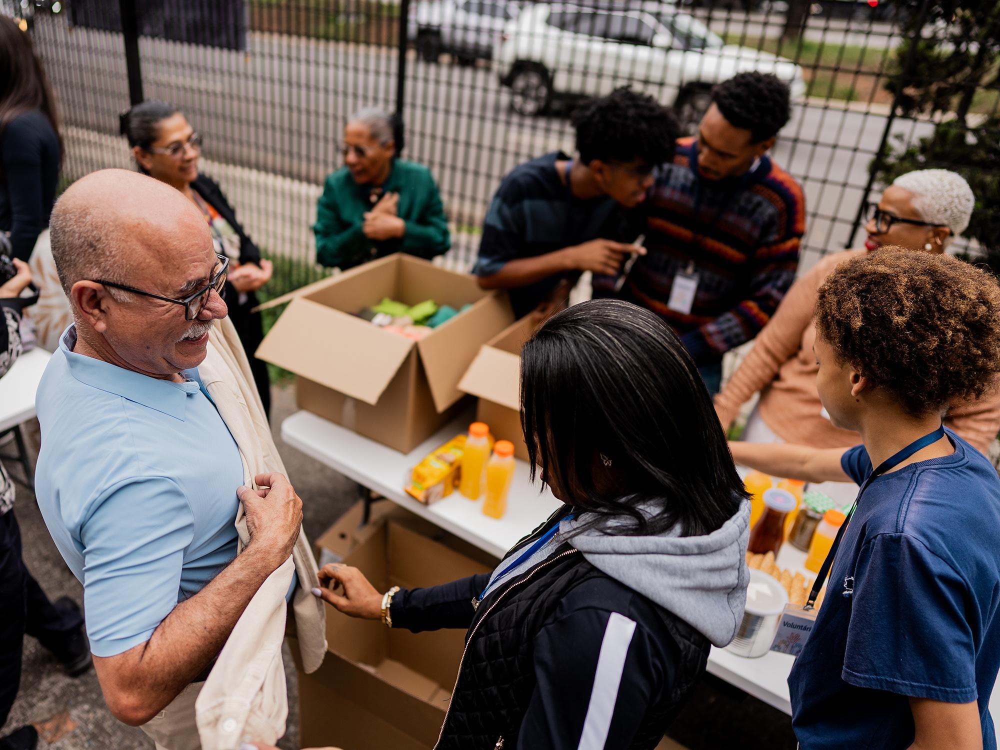 A candid moment capturing community workers organizing clothing donations.
