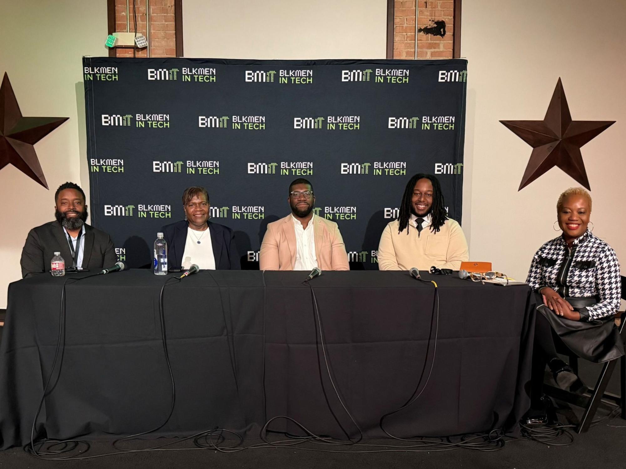 five panelists seated at conference table