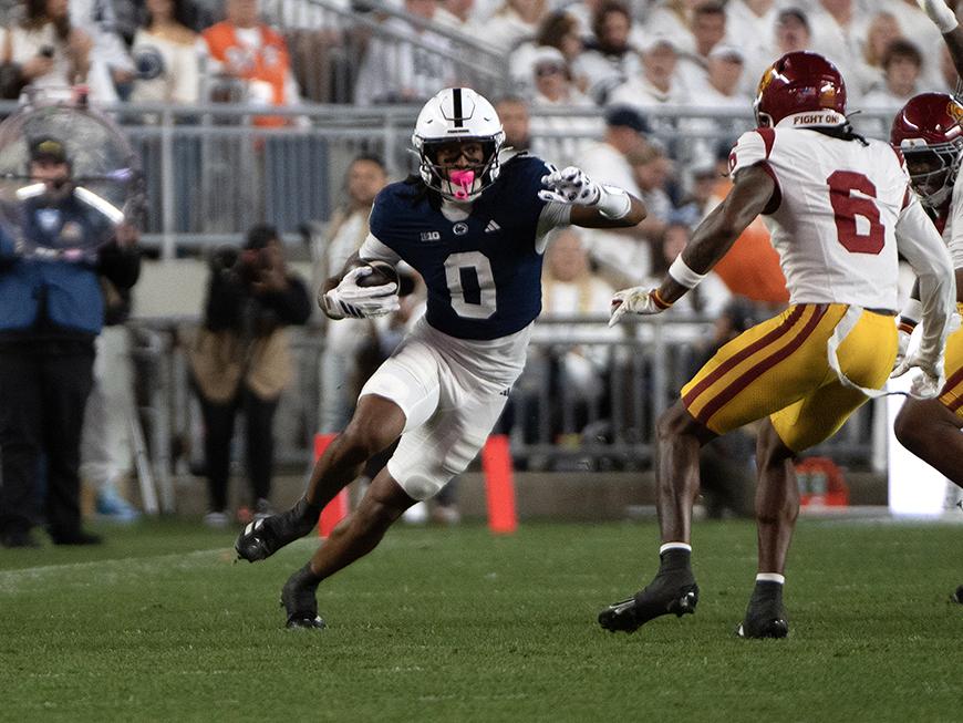 Wide receiver tries to avoid defender