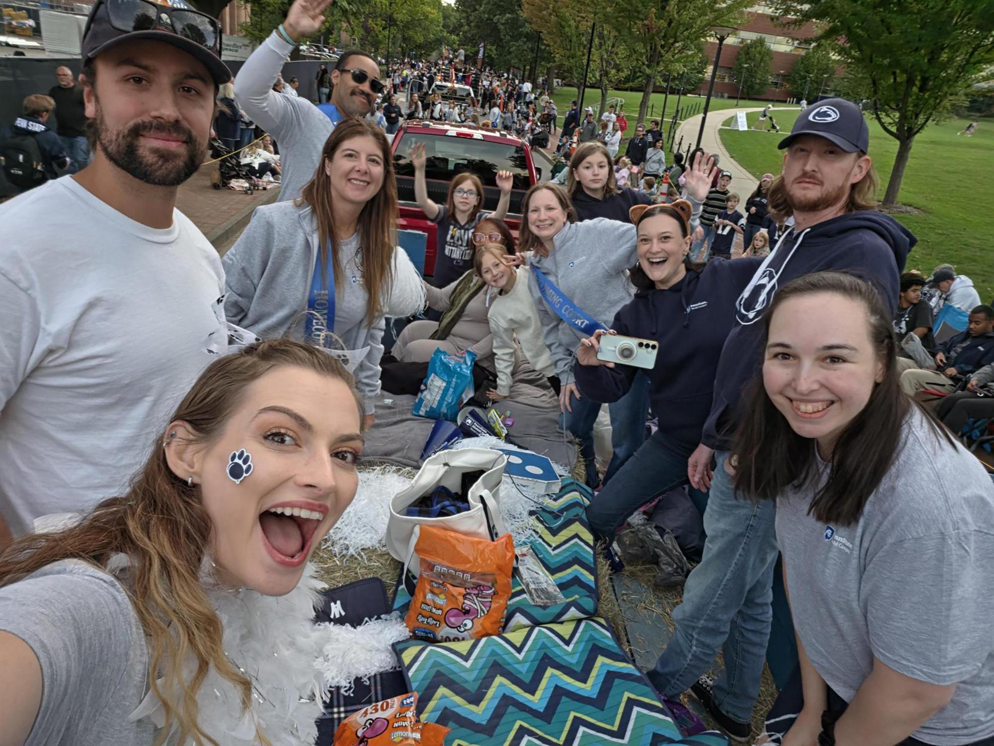 A group of people take a selfie on a parade float.