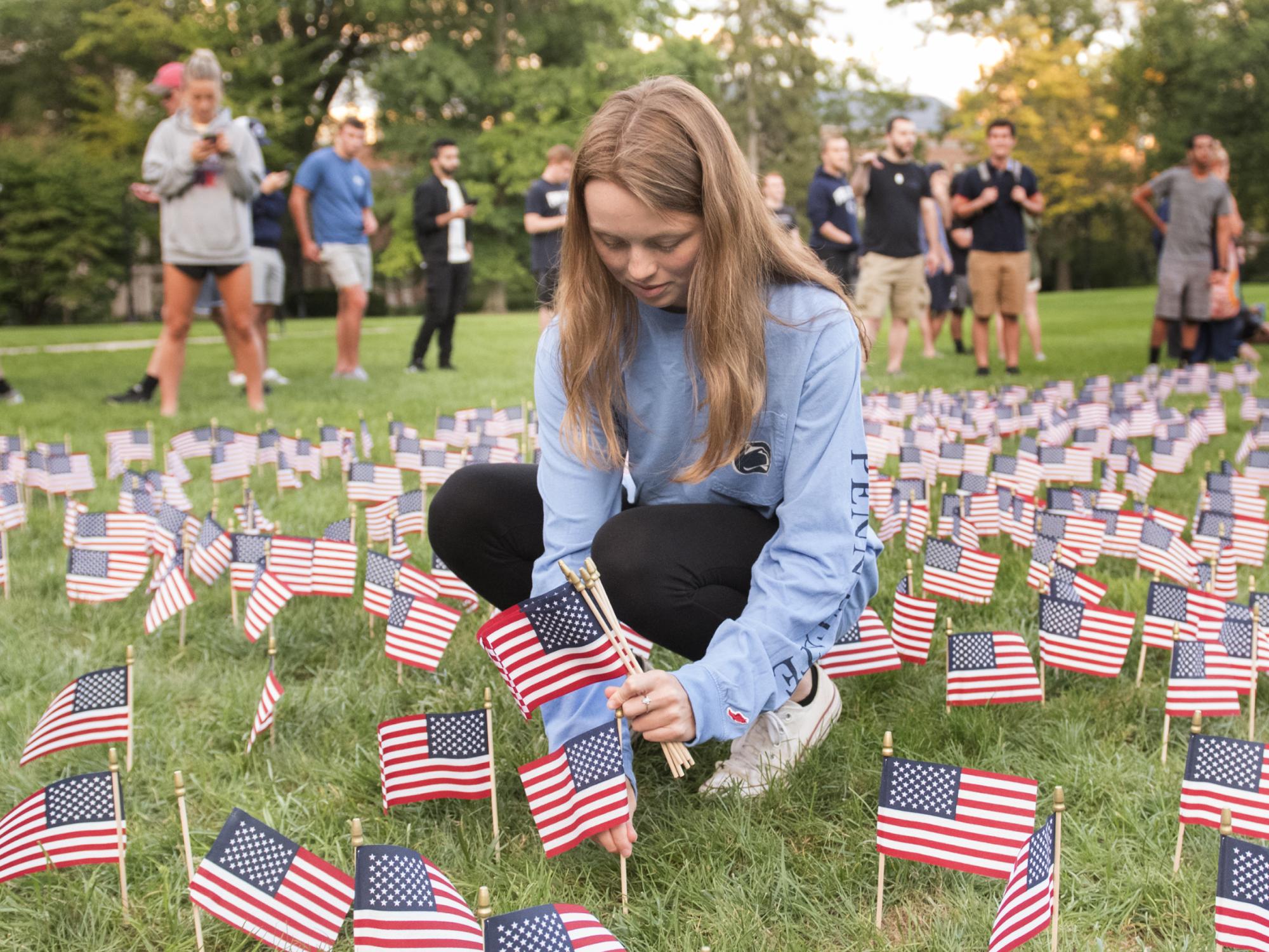 student with flags at Old Main