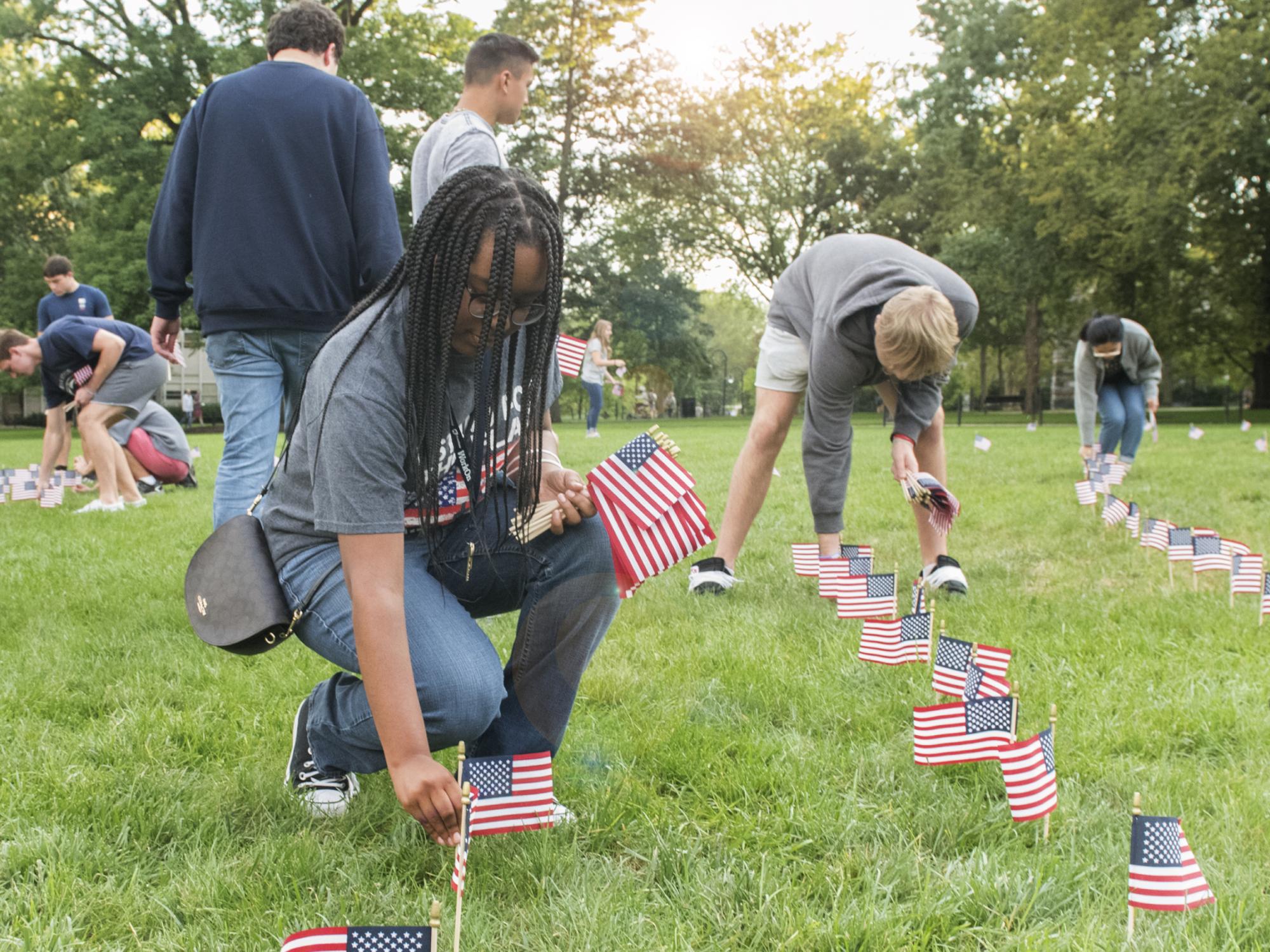 Micah Chandler with flag at Old Main