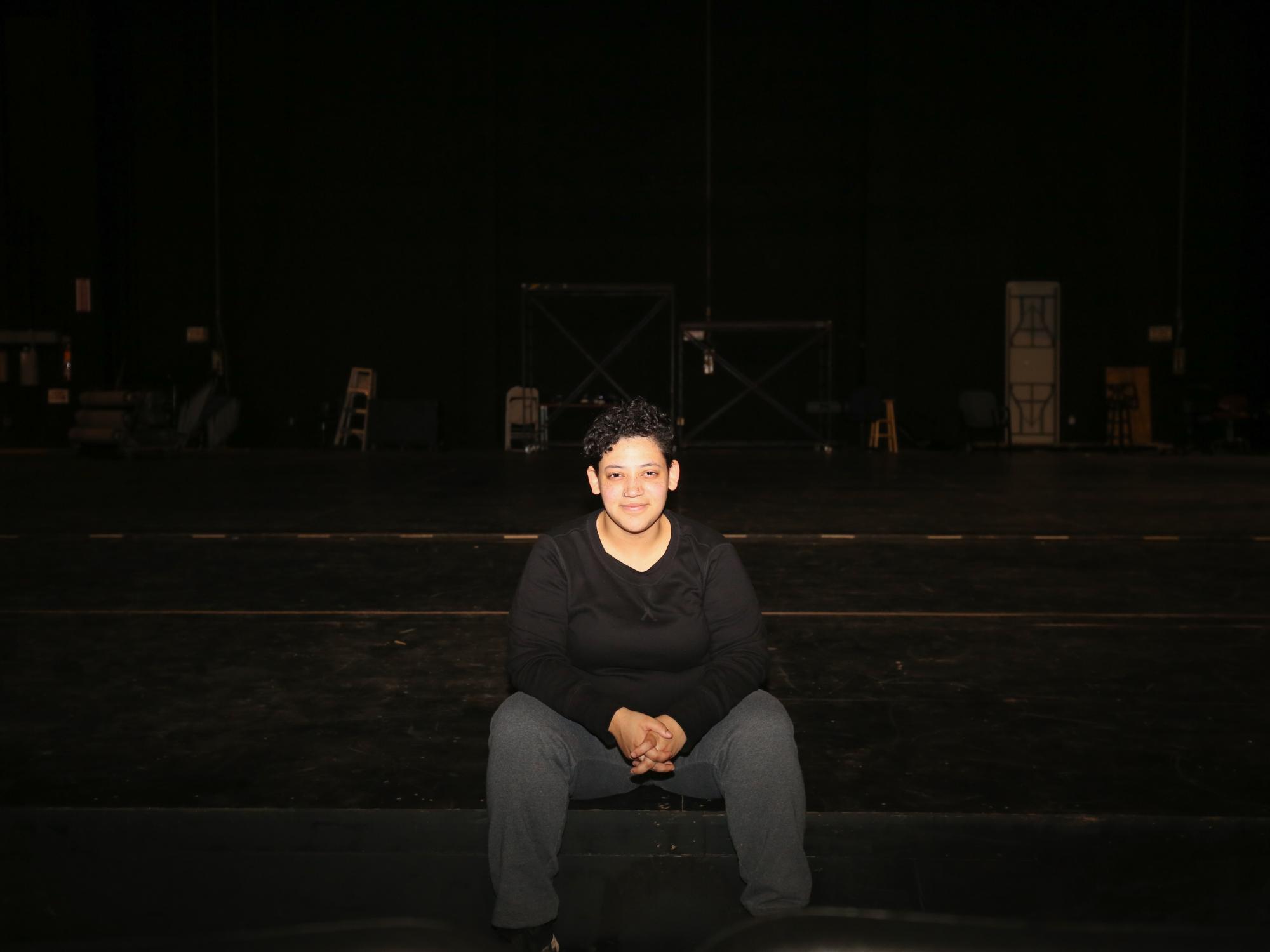  Mariah Claiborne sits on the Playhouse Stage in the dark
