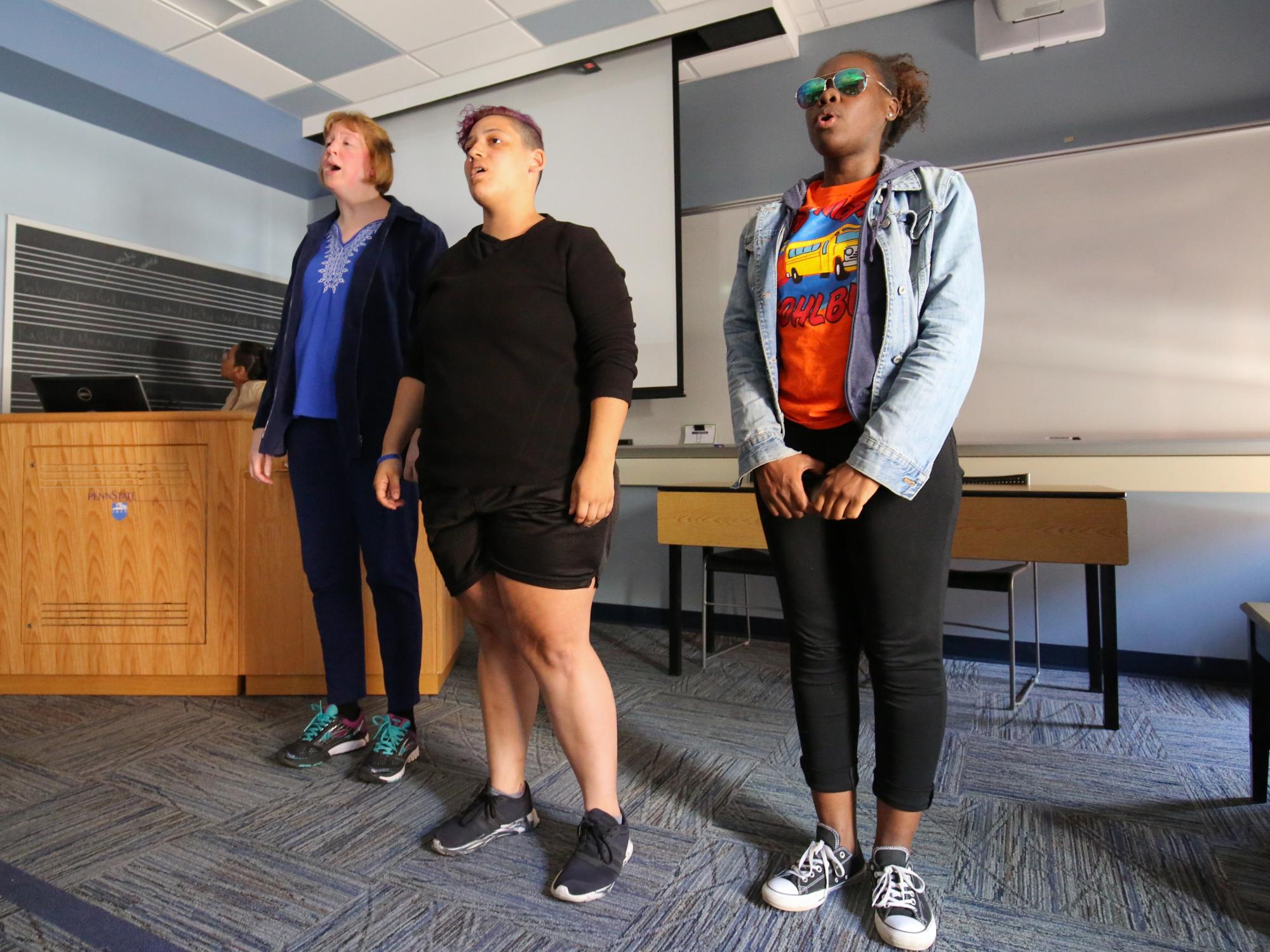 Students, Jennifer Miller, Mariah Claiborne, Delisa Williams, perform a spiritual during class. 