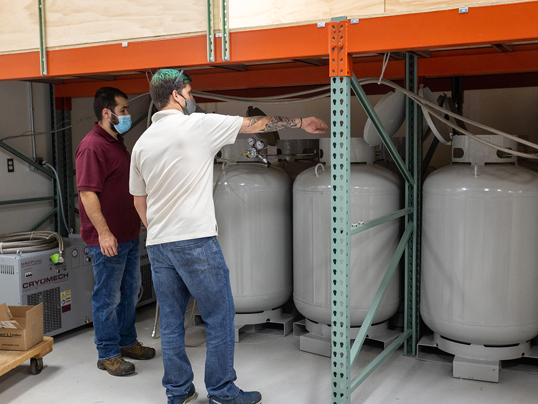 Cryomech technicians work on the Chemistry Building's helium recovery system installation.