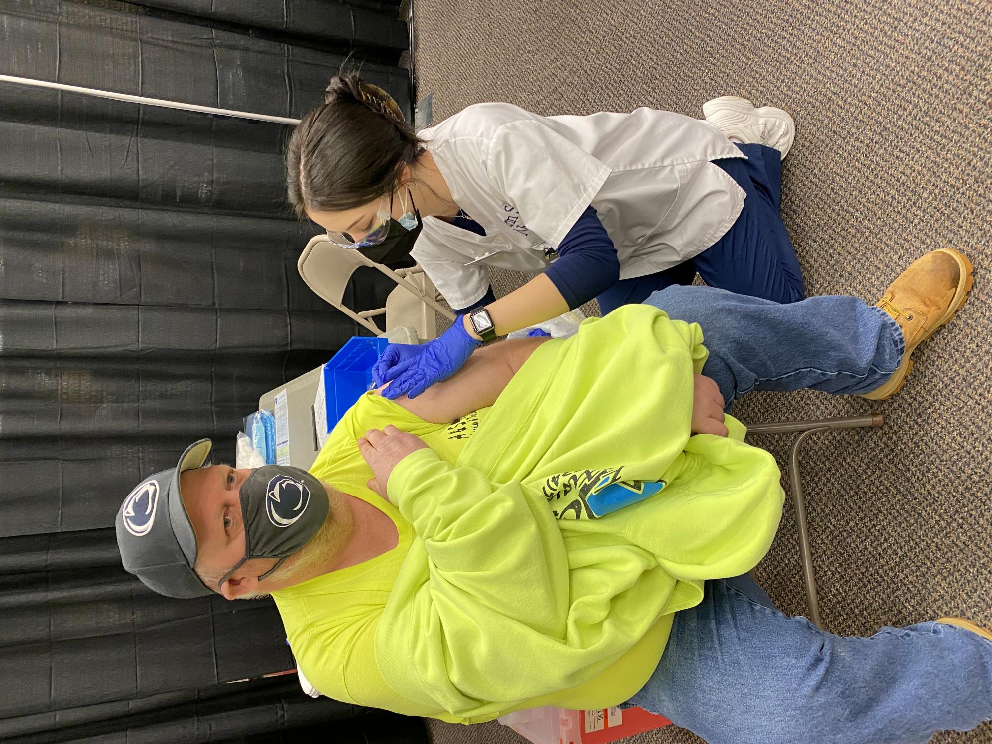 Sophomore Nursing student Rachel Beaumariage administers a vaccine to Jim Madison (shared with permission).
