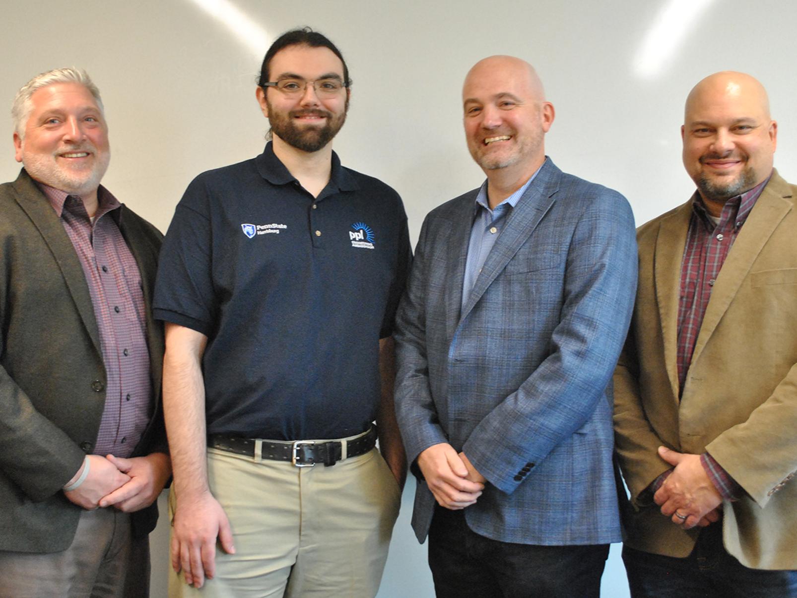 Four men standing together