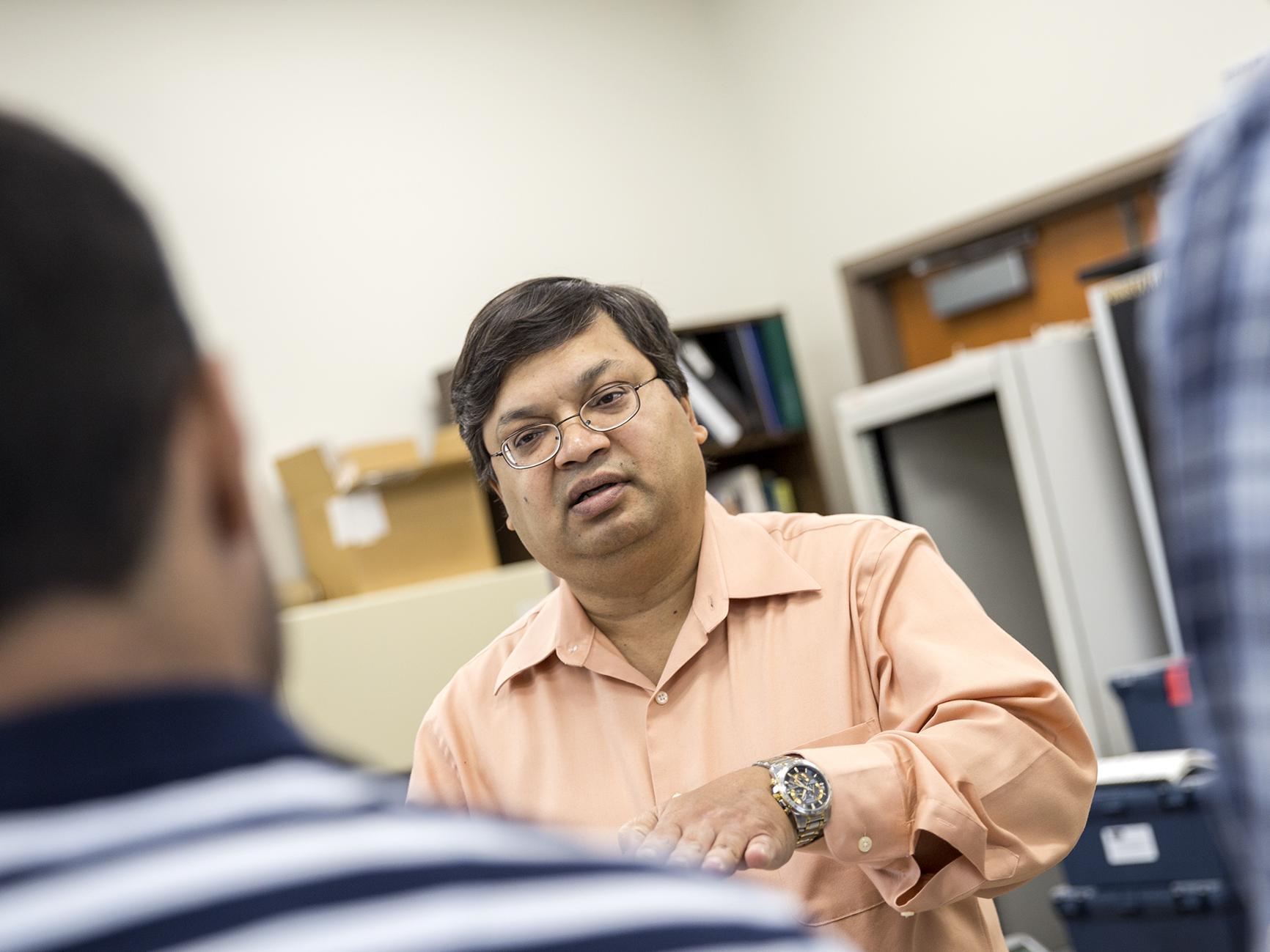 Professor Vittal Prabhu speaks to two of his graduate students