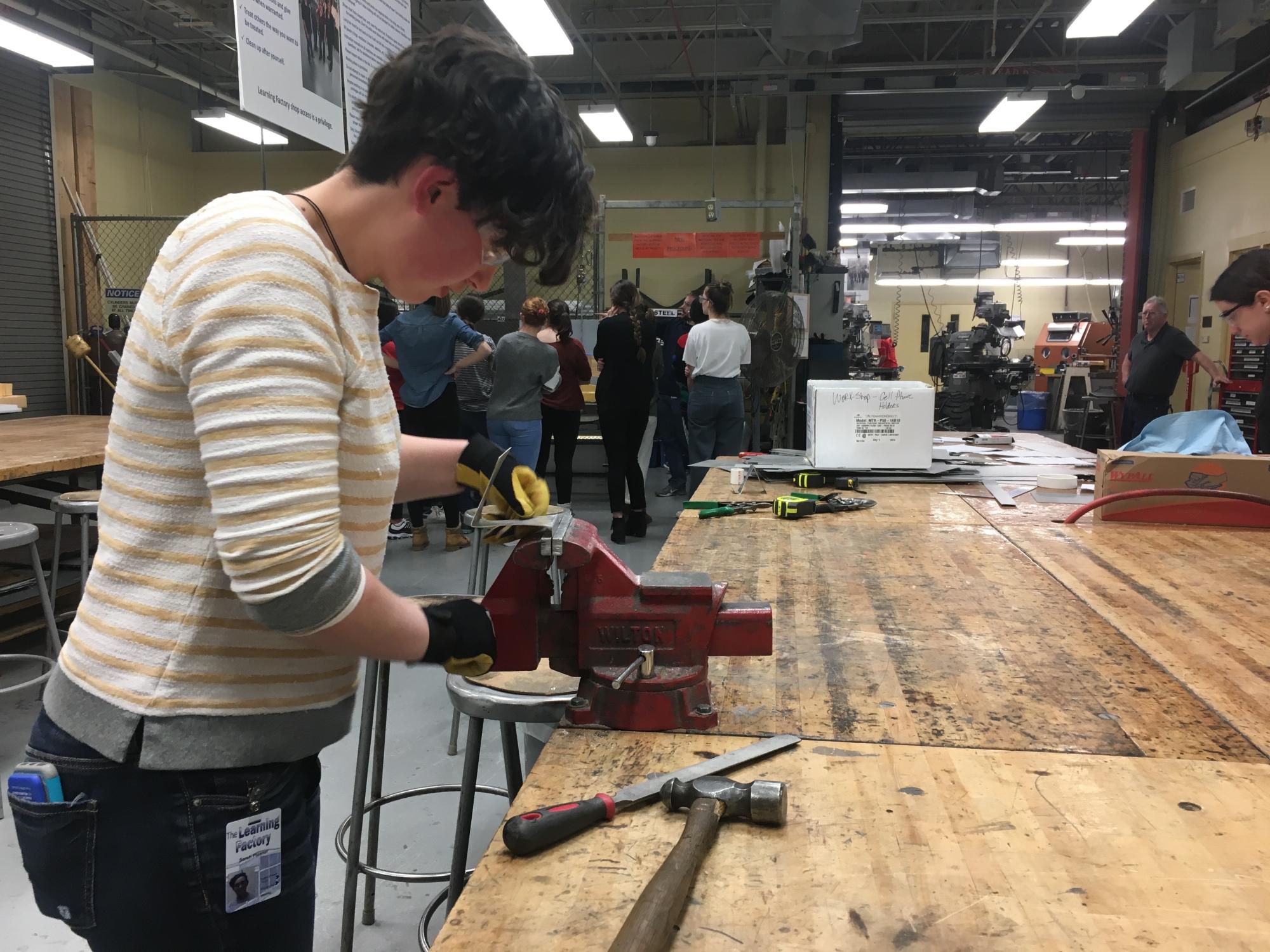 Engineering student uses vice to bend sheet metal