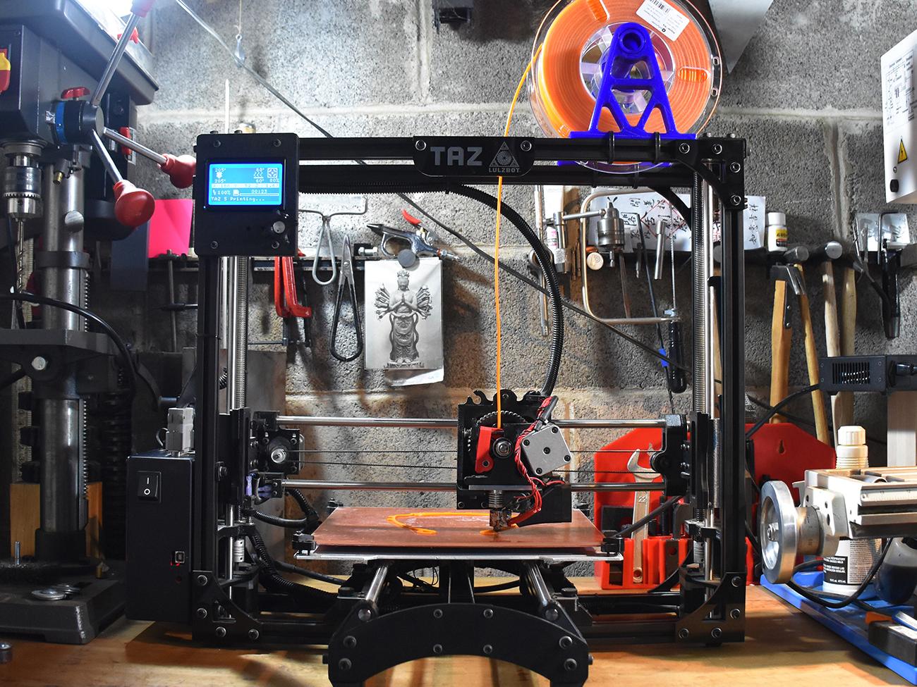 A small 3D printer on Marcus Shaffer's workstation at his home.