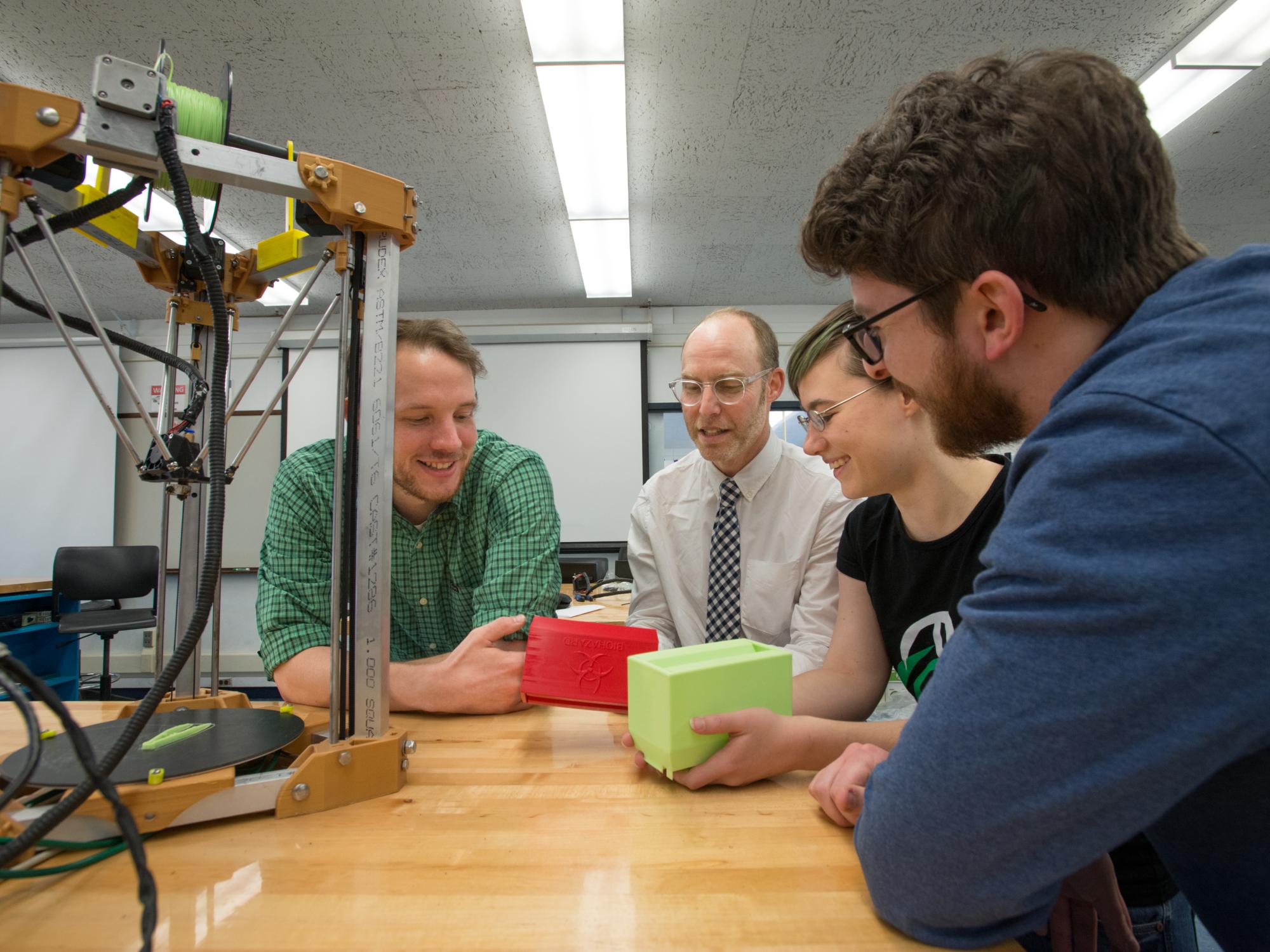 The Kijenzi venture team works on a 3D-printed design
