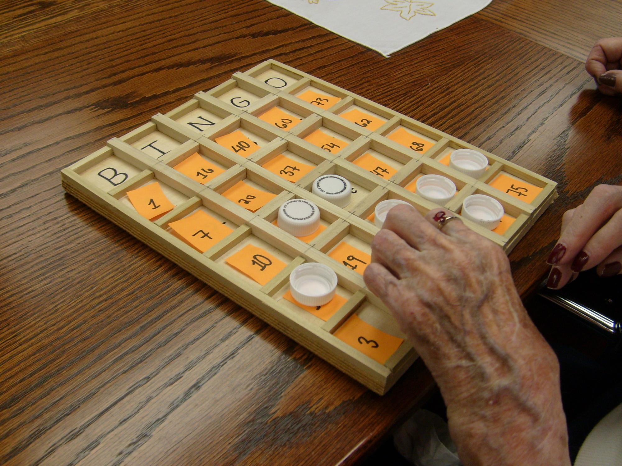 Ruby Hassey, a 103-year-old resident of Quincy Village, samples a prototype of a Bingo board.