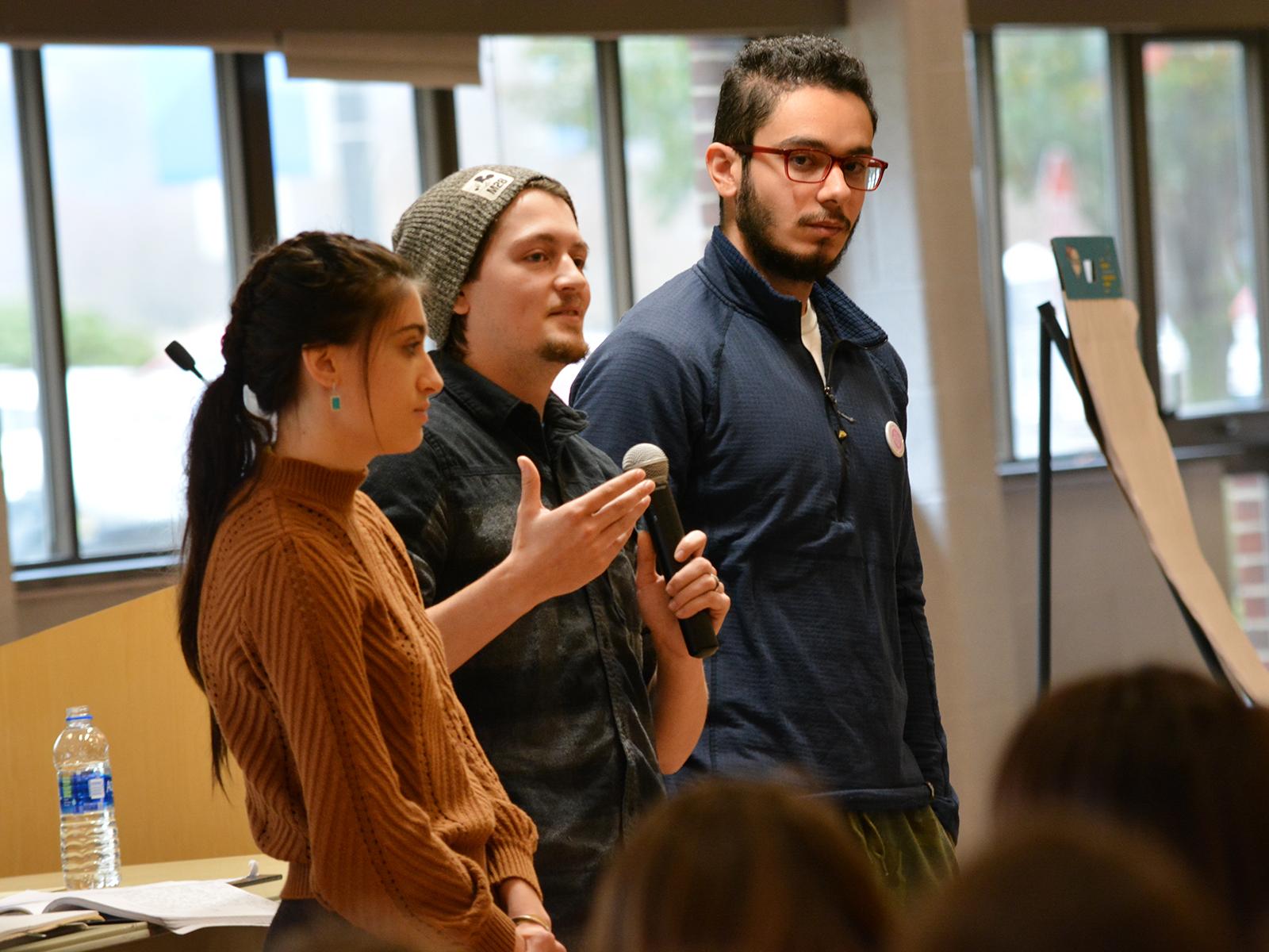 students speaking with microphone