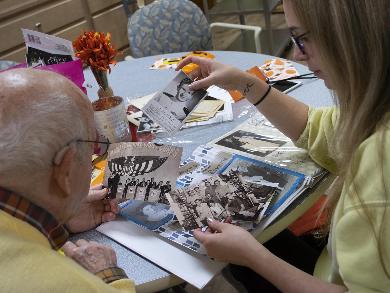 student and man looking at photos