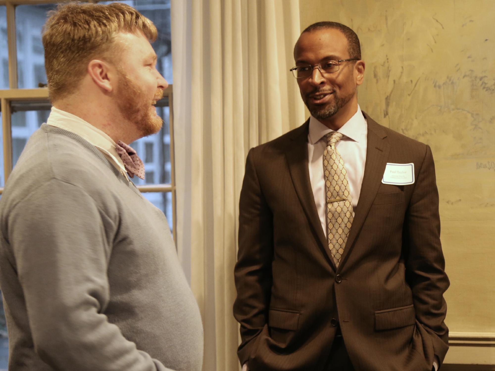 Associate Dean Paul Taylor talks with a graduate student from the Department of Germanic and Slavic Languages