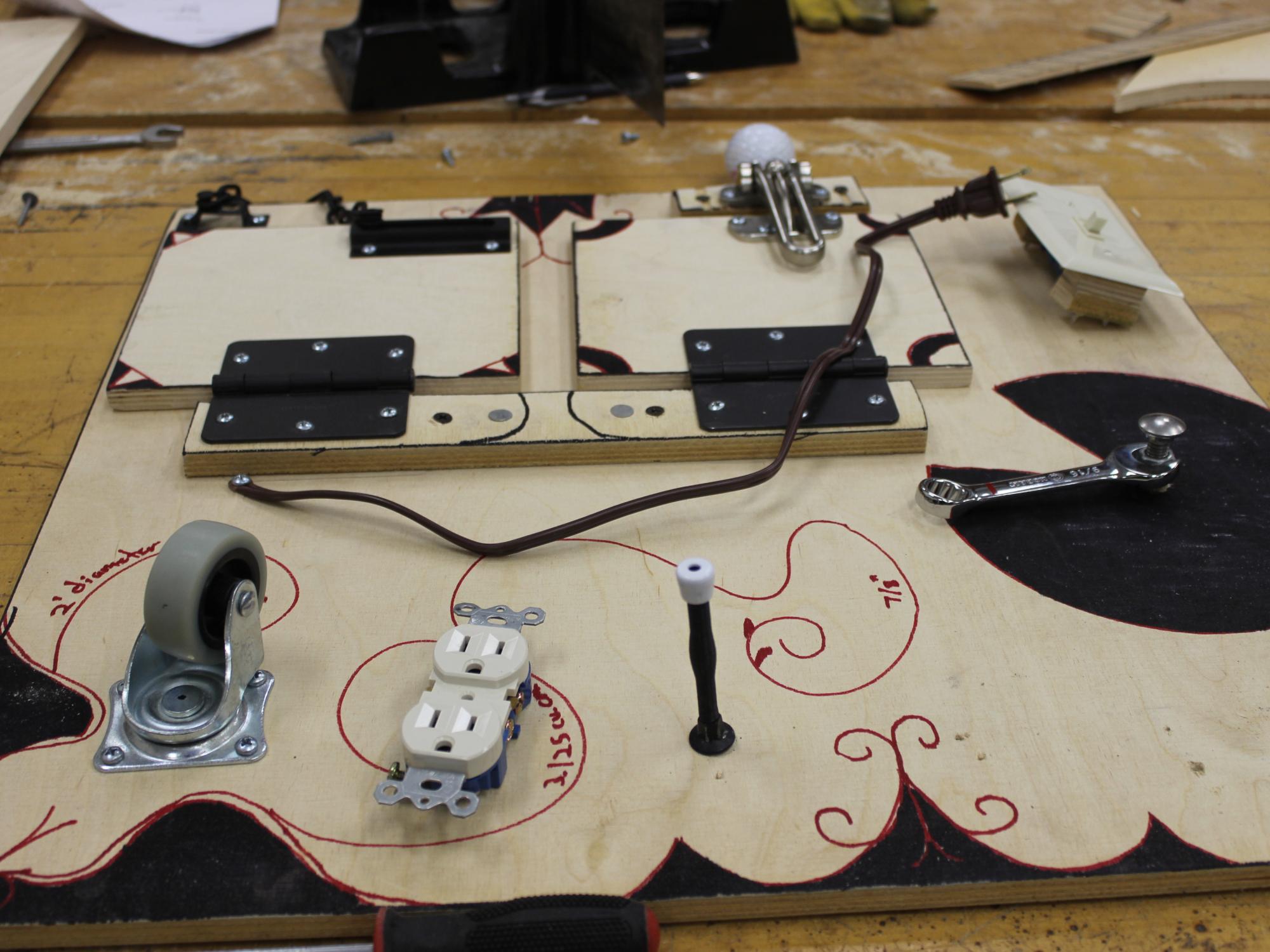 A busy board designed by engineering students Hunter Murray, Joe Fletcher, and Carter McCleary that is centered on typical masculine activities.