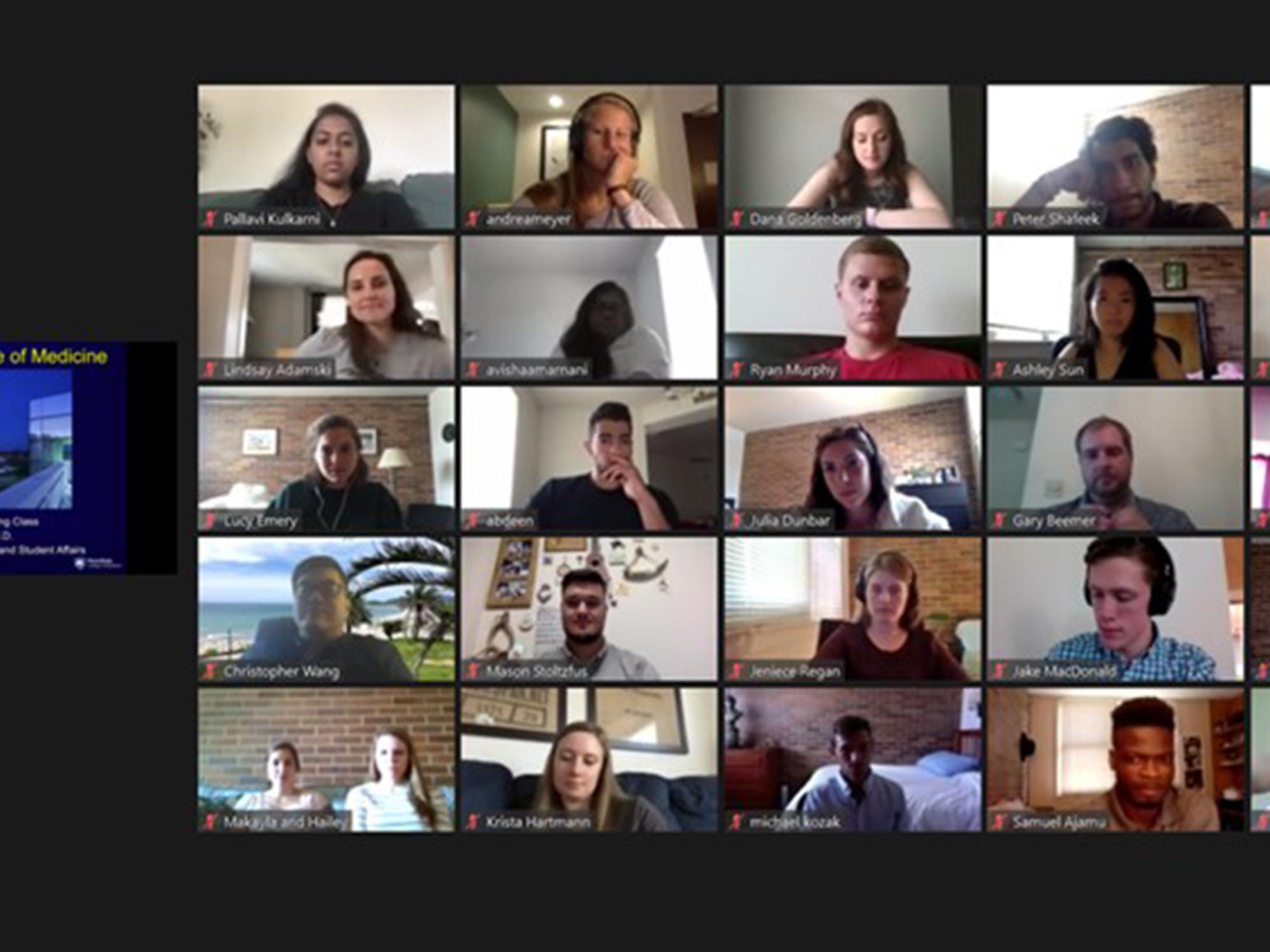 The faces of students participating in a virtual meeting appear on a screen in a grid of five columns and five rows, with a small image of the presenter’s screen to the left of the students’ faces.