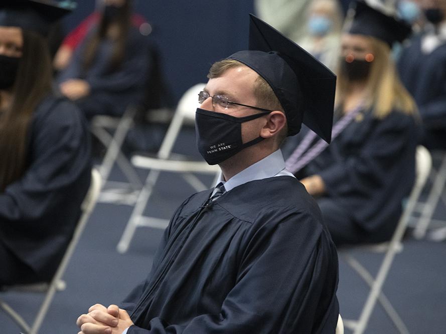 Graduate Brandon Demchak sits in the audience